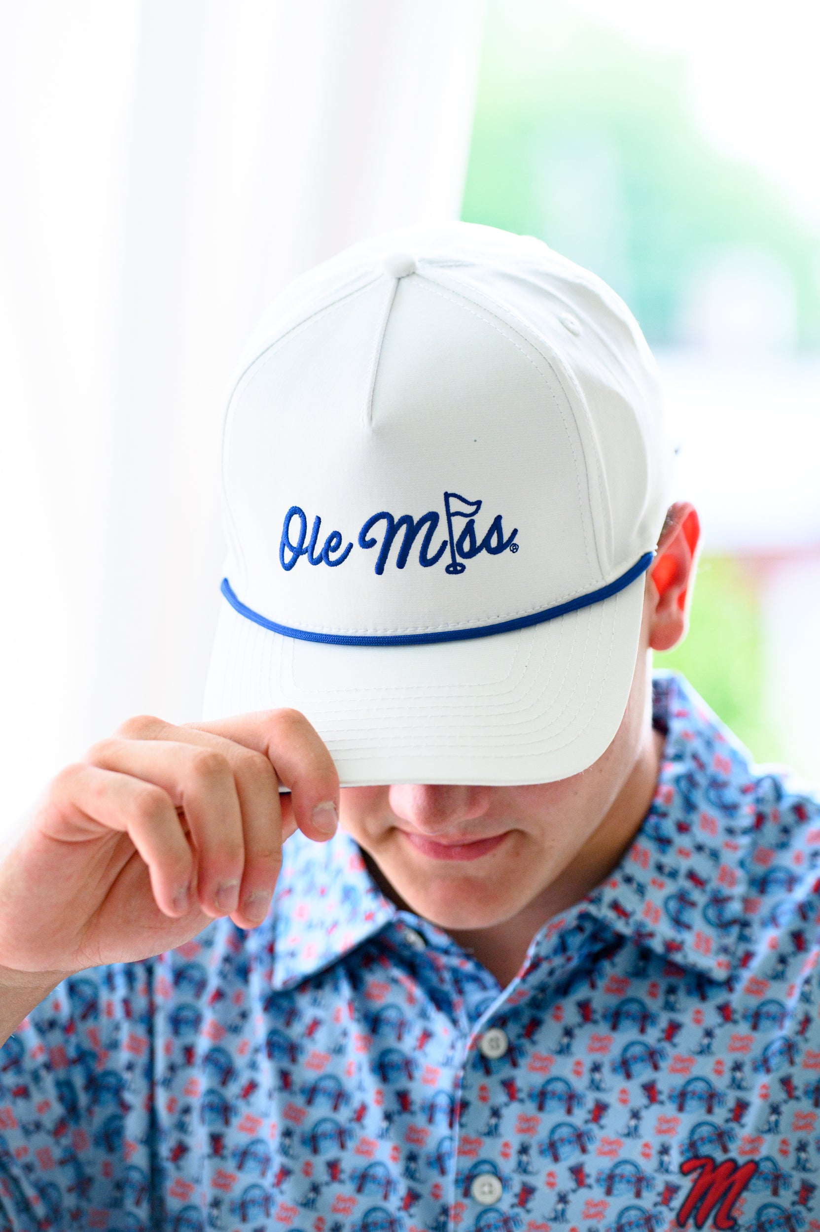 Ole Miss White Hat with Blue embroidery “Ole Miss” with a golf flag representing the “I” in “Miss”