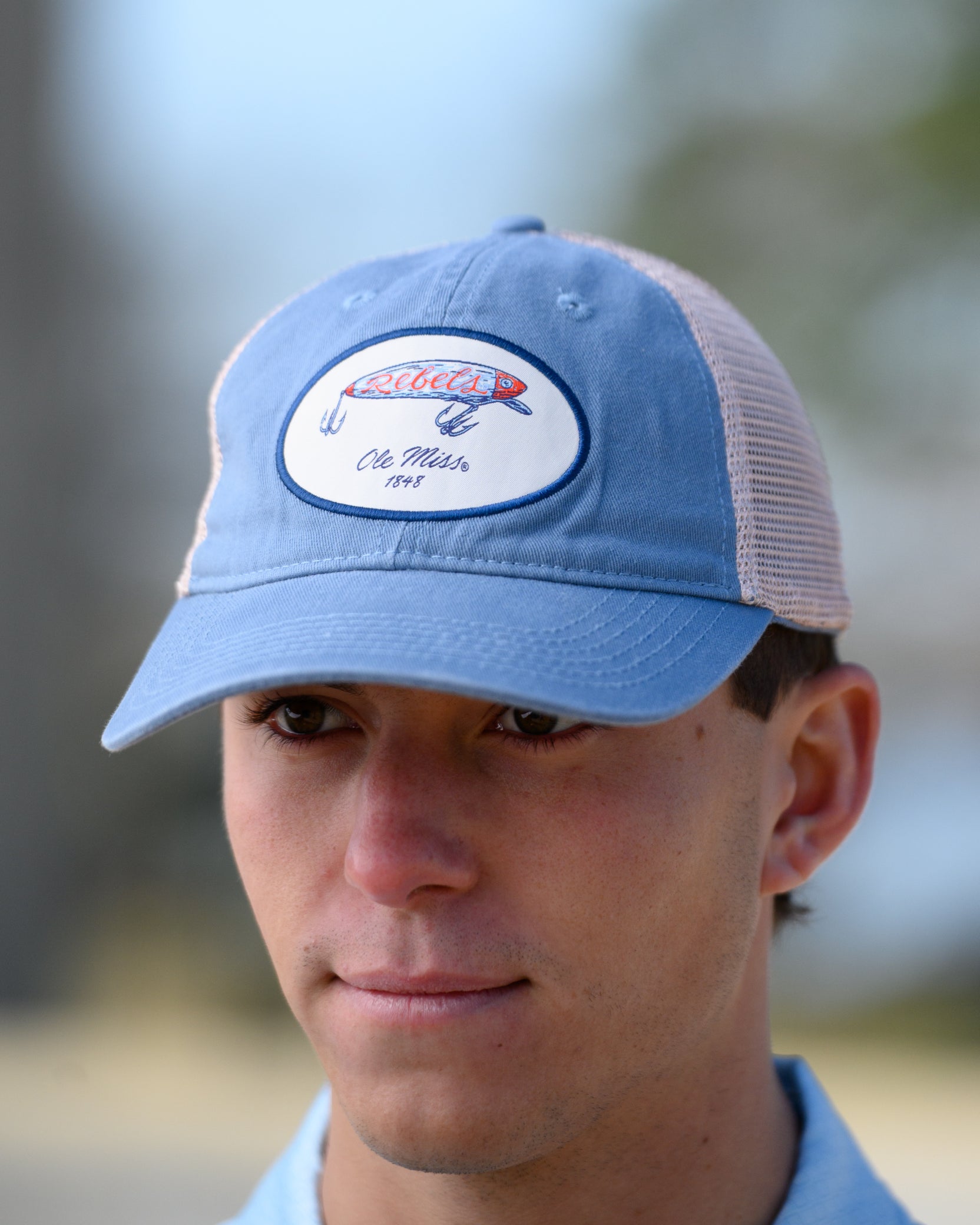 Ole Miss Dusty Blue Hat with a fishing lure with Red script “Rebels”
