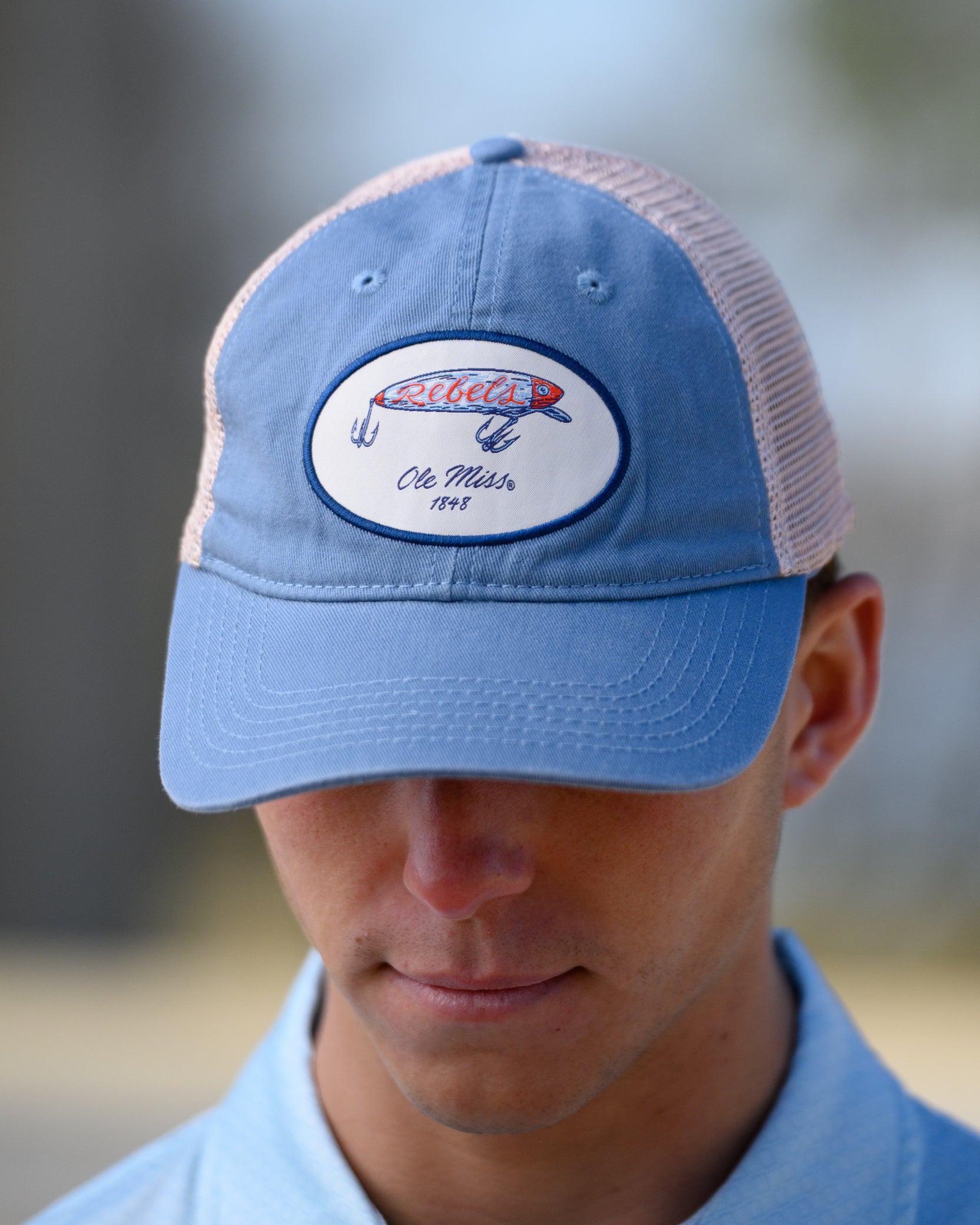 Ole Miss Dusty Blue Hat with a fishing lure with Red script “Rebels”