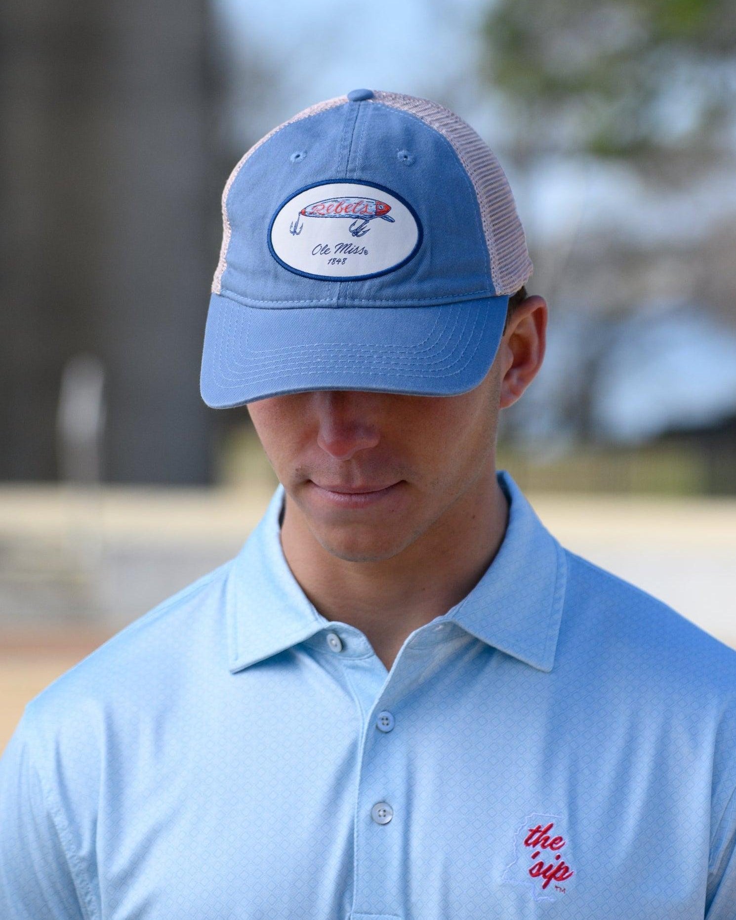 Ole Miss Dusty Blue Hat with a fishing lure with Red script “Rebels”