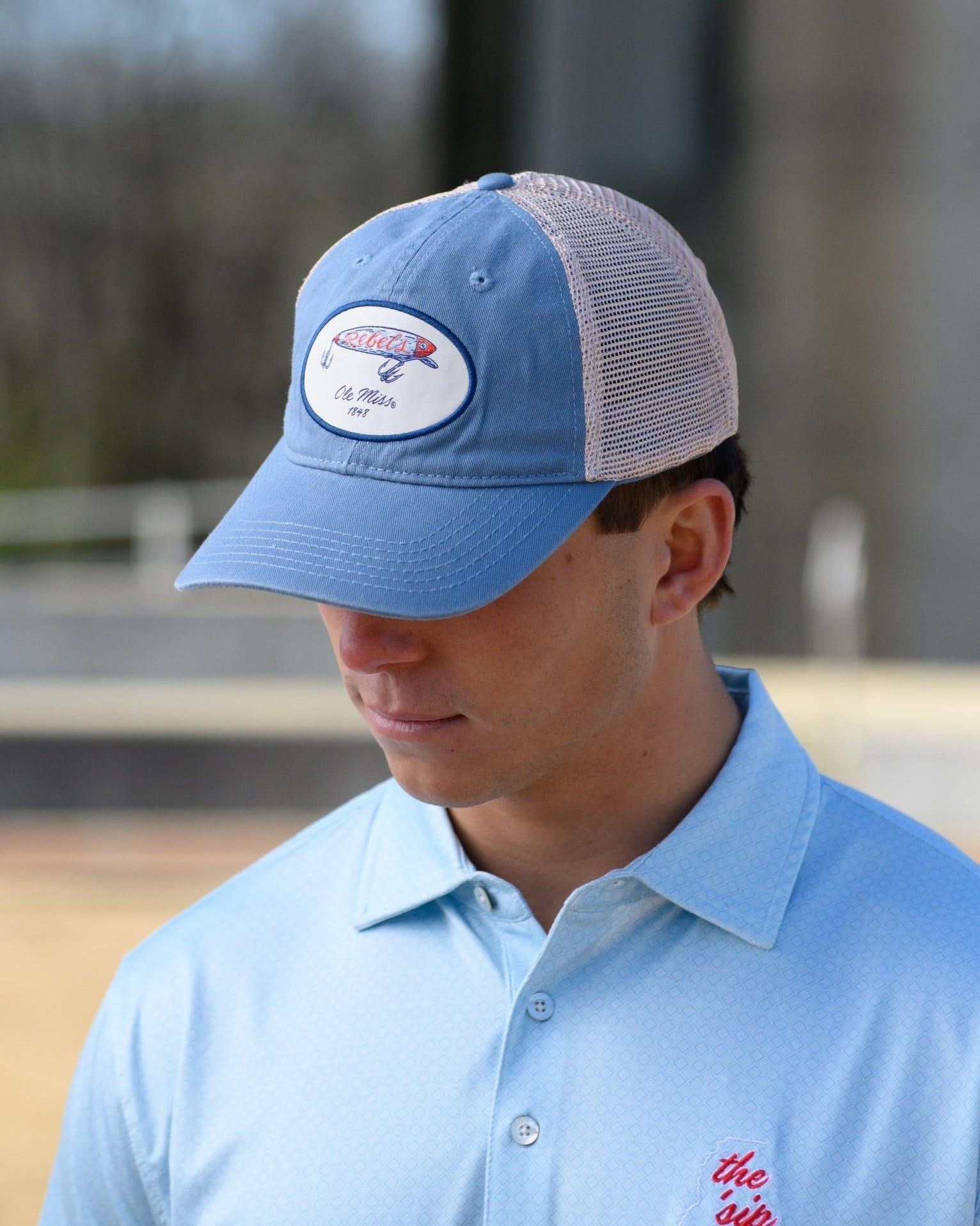Ole Miss Dusty Blue Hat with a fishing lure with Red script “Rebels”