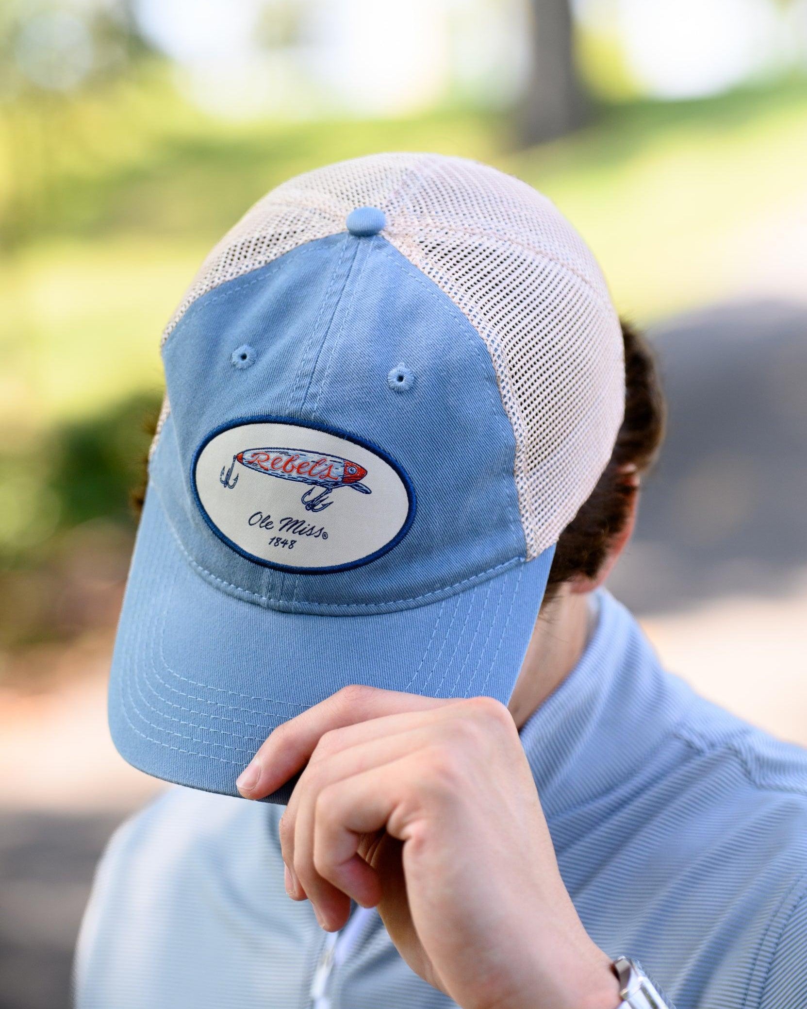 Ole Miss Dusty Blue Hat with a fishing lure with Red script “Rebels”
