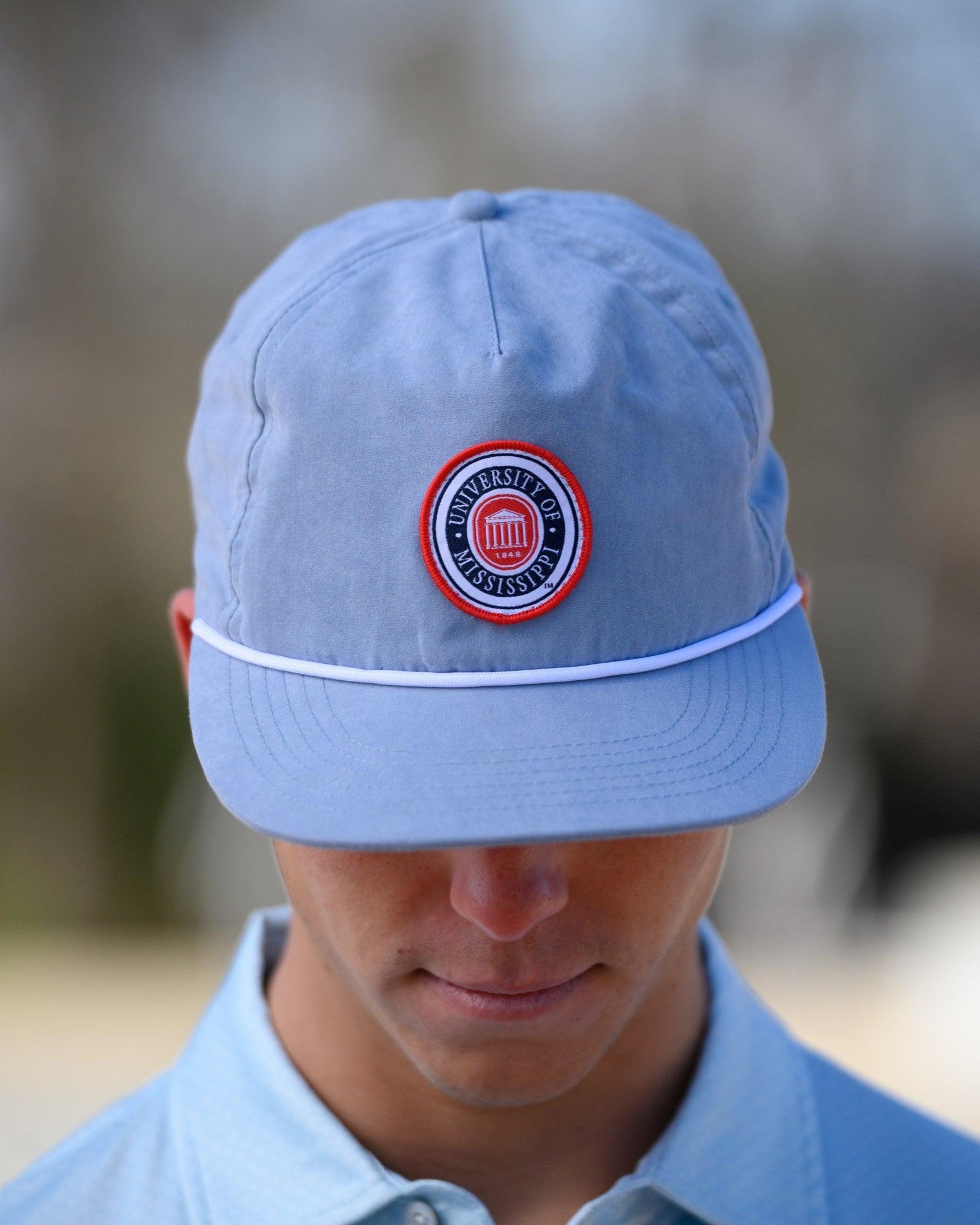 Ole Miss Dusty Blue Hat with a patch of the Ole Miss Seal