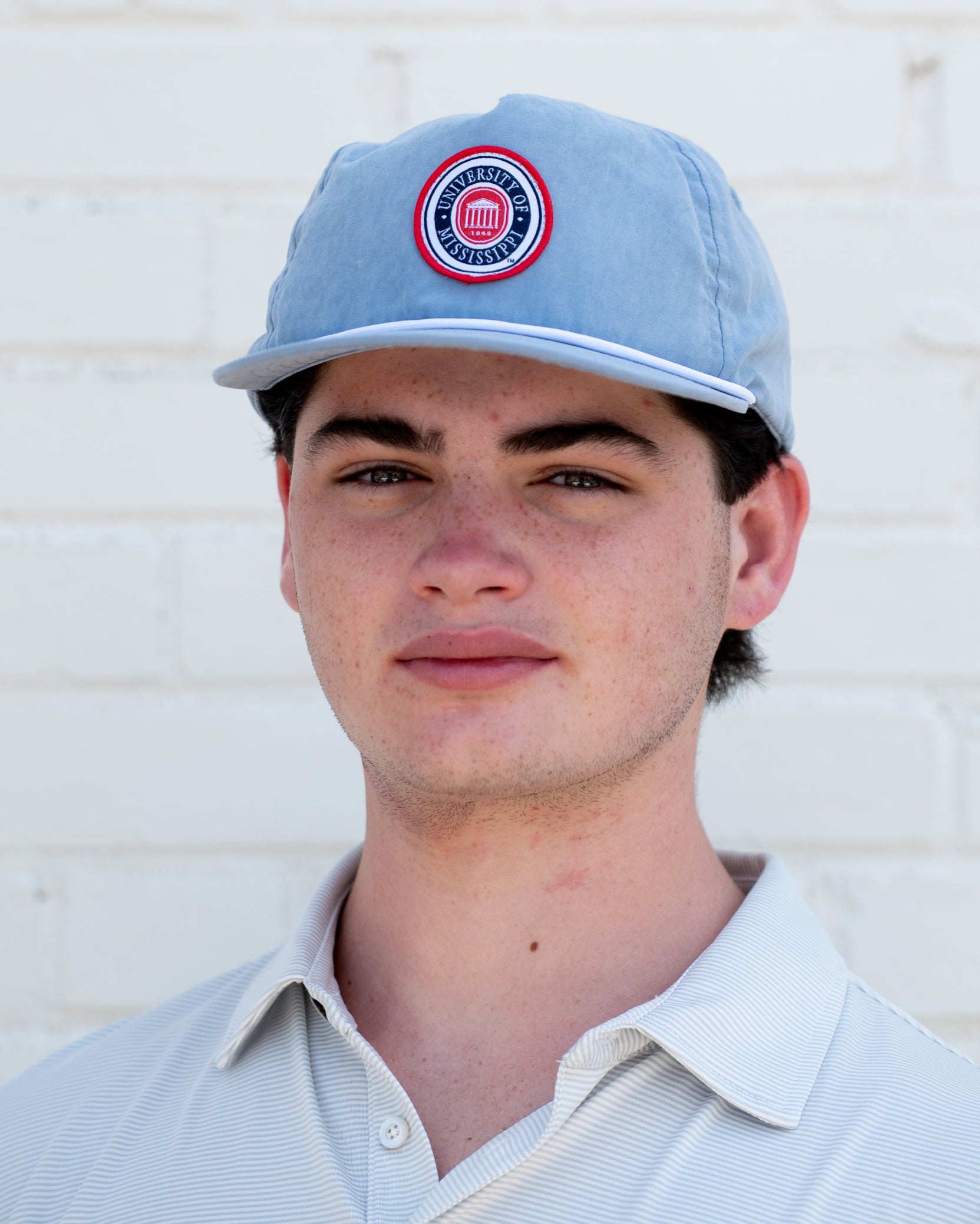 Ole Miss Dusty Blue Hat with a patch of the Ole Miss seal