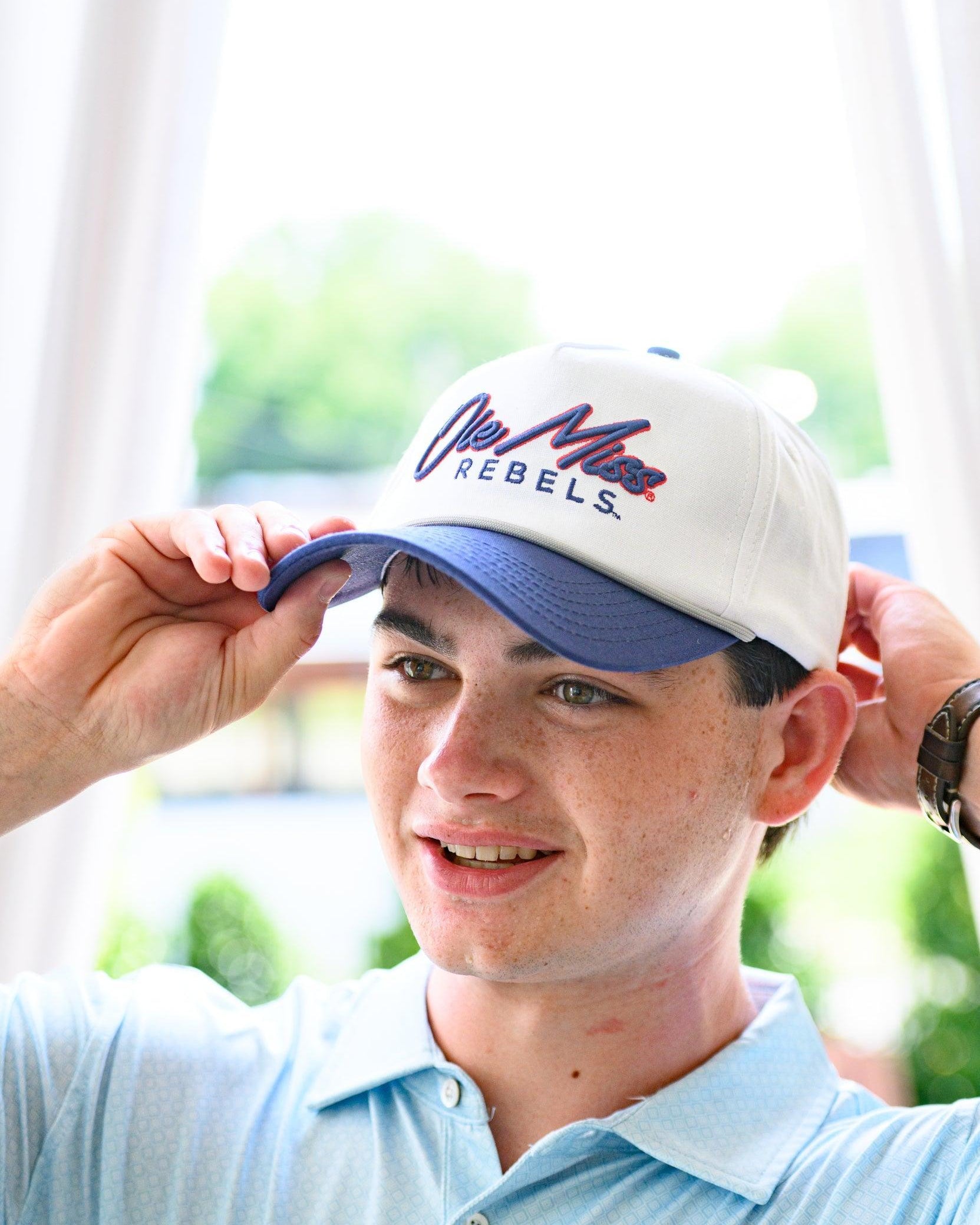 Ole Miss White and Navy Hat with Navy embroidery “Ole Miss” and Navy text “Rebels”