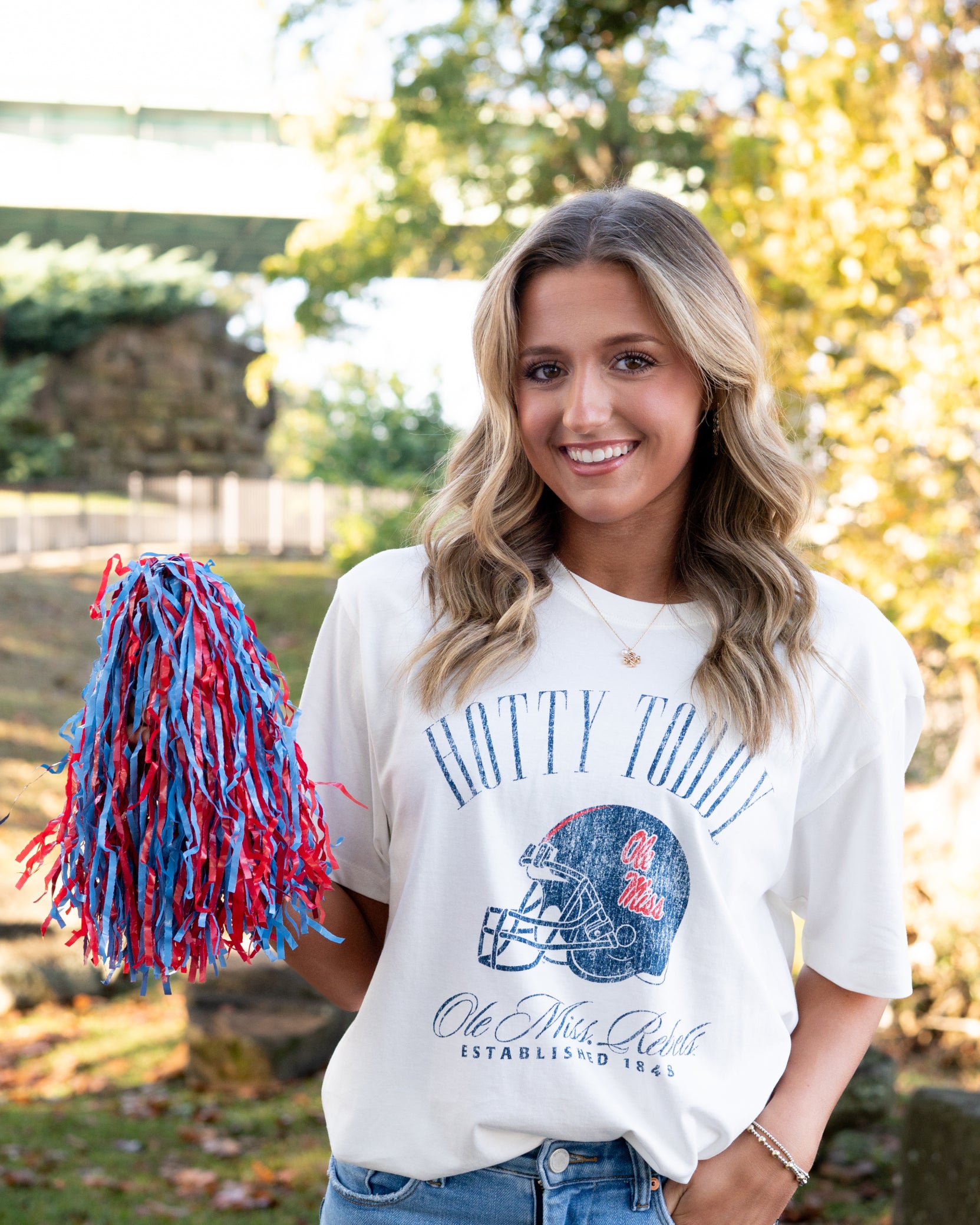 Ole Miss Ivory T-Shirt with Blue text “Hotty Toddy” above an image of a football helmet
