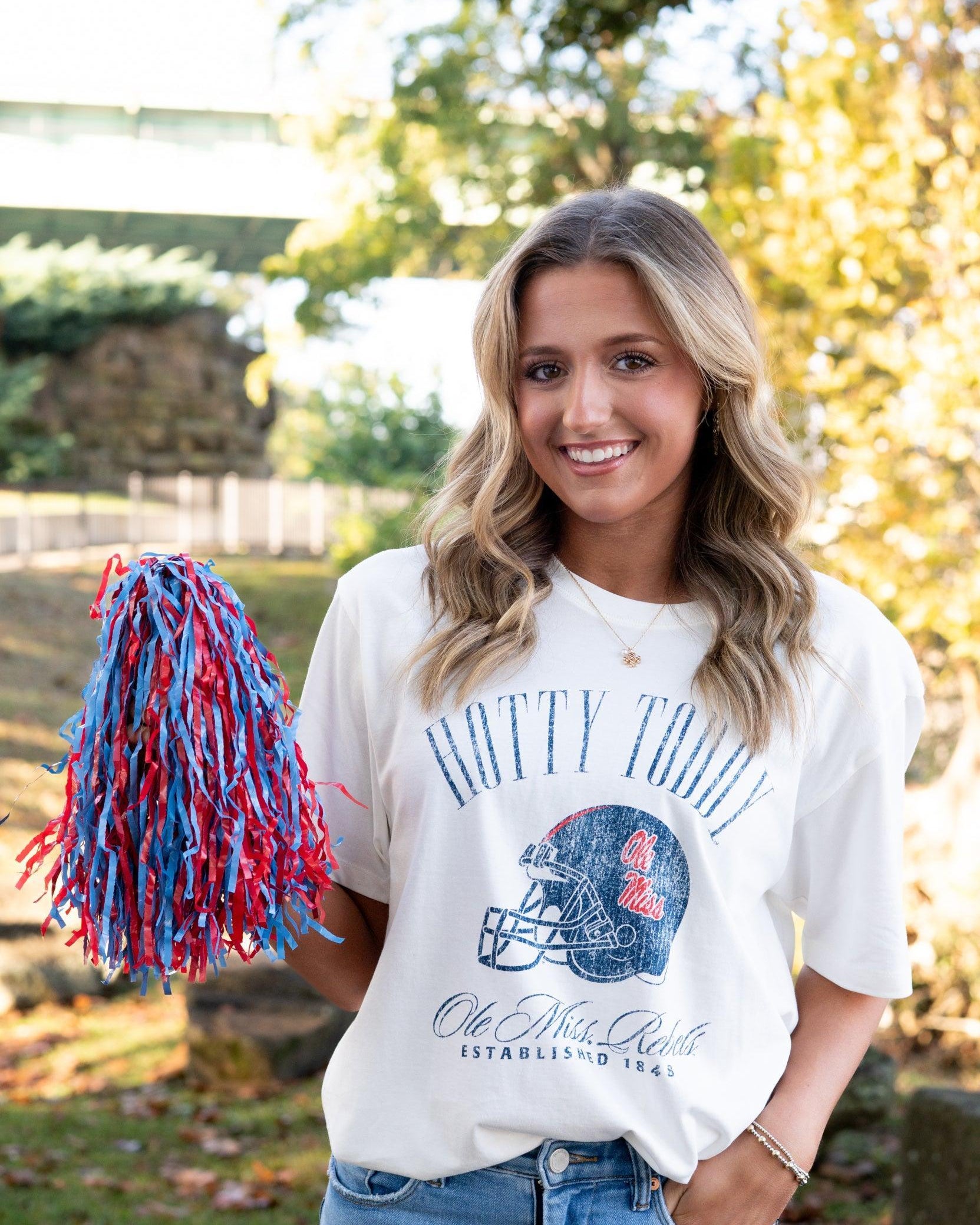 Ole Miss Ivory T-Shirt with Blue text “Hotty Toddy” above an image of a football helmet