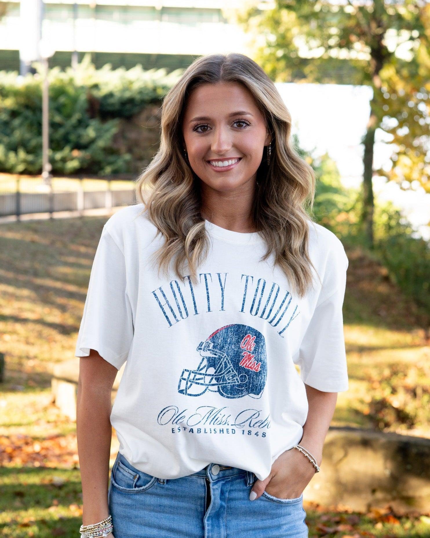 Ole Miss Ivory T-Shirt with Blue text “Hotty Toddy” above an image of a football helmet