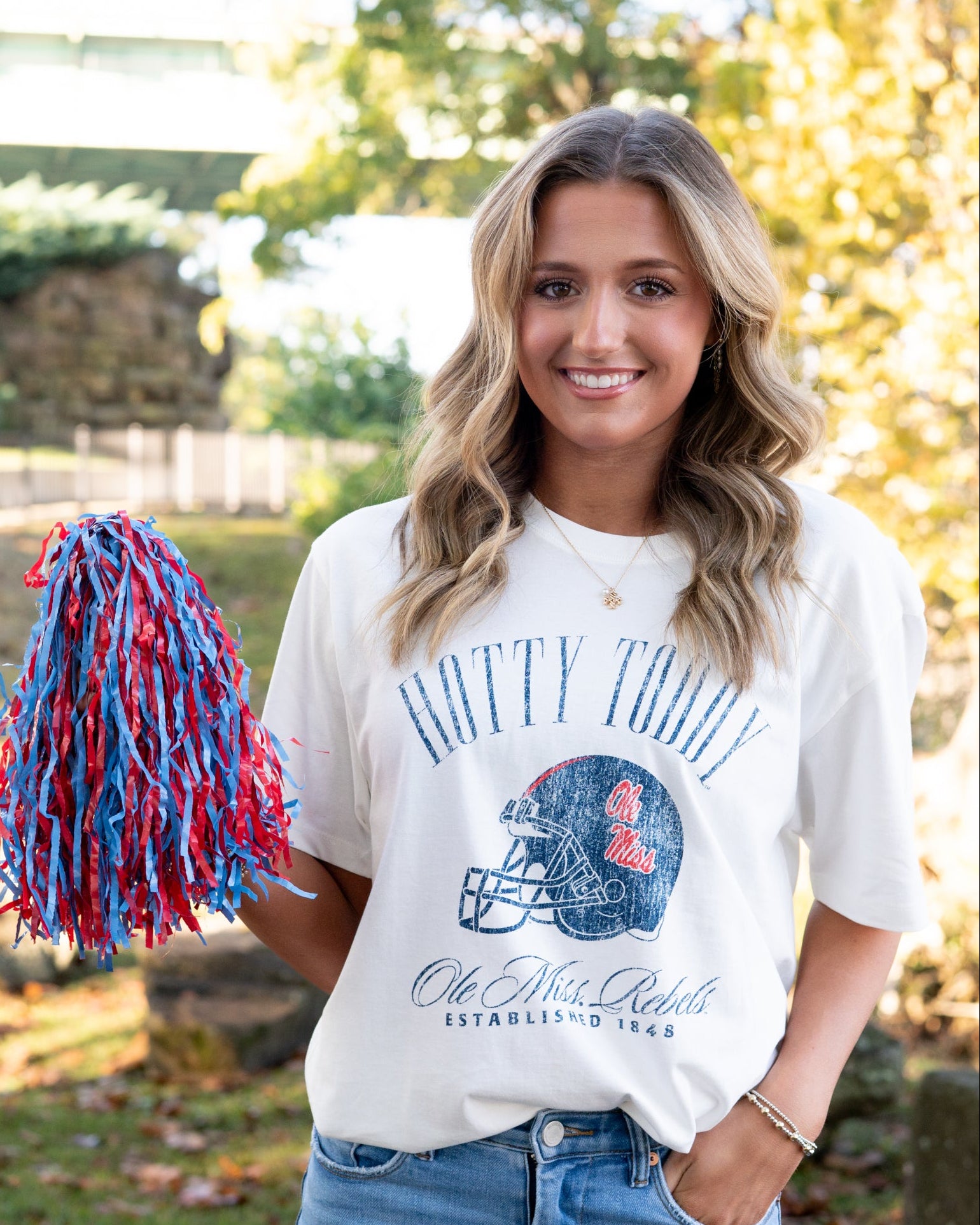 Ole Miss Ivory T-Shirt with Blue text “Hotty Toddy” above an image of a football helmet