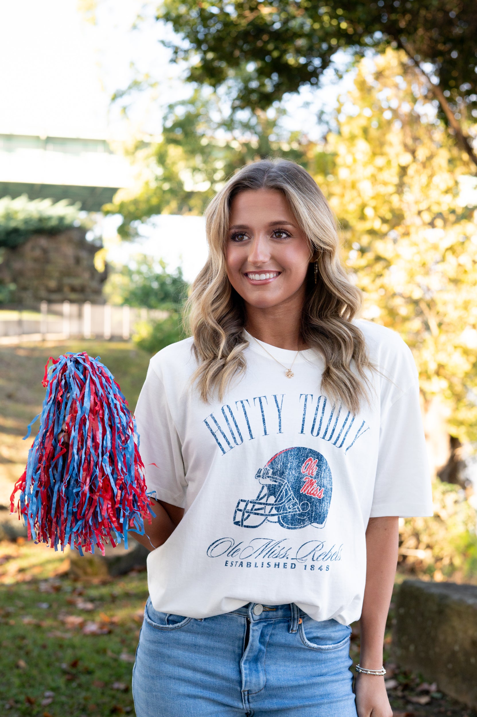 Ole Miss Ivory T-Shirt with Blue text “Hotty Toddy” above an image of a football helmet