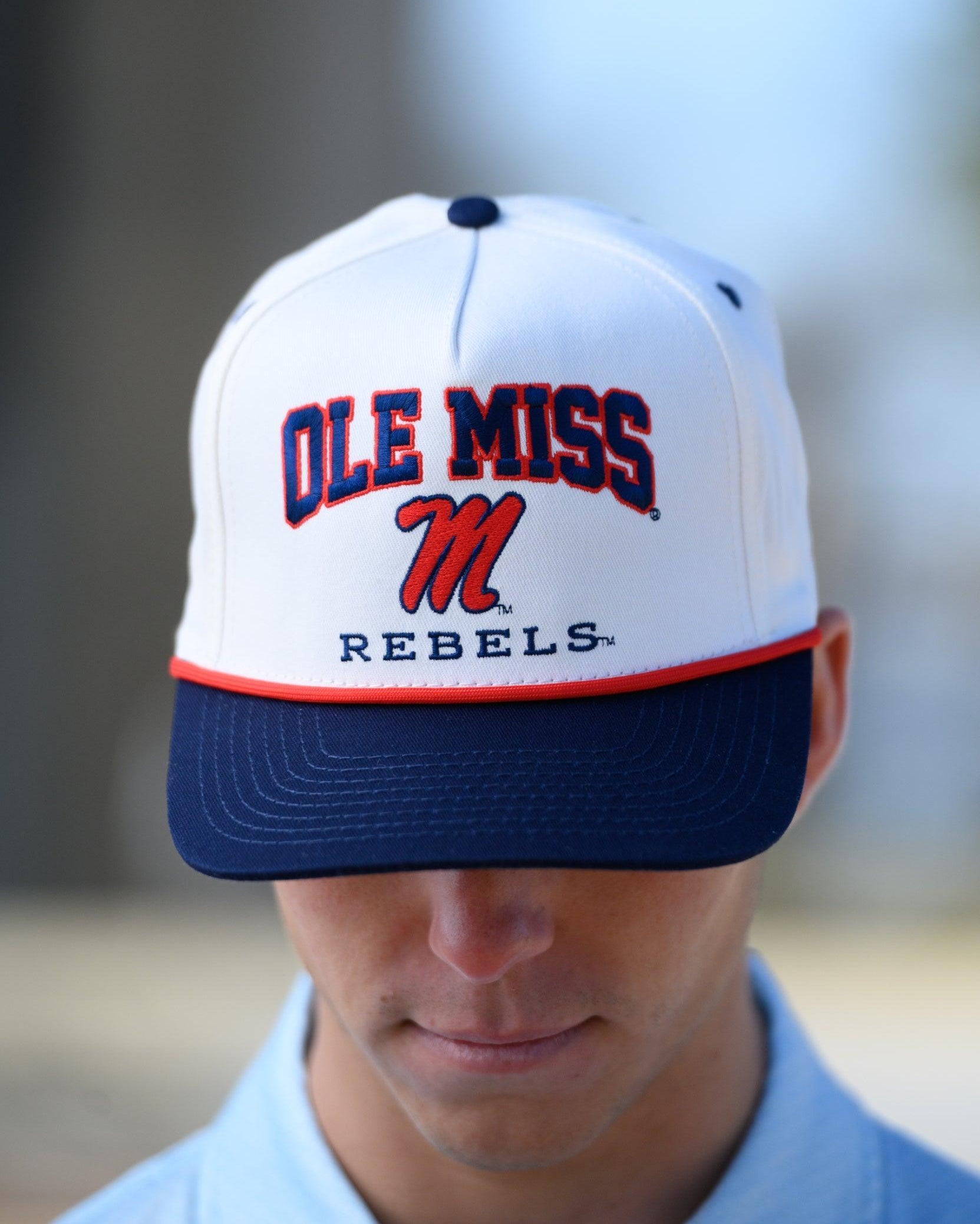 Ole Miss Cream and Navy Hat with embroidered text “Ole Miss Rebels” surrounding the Script M Logo