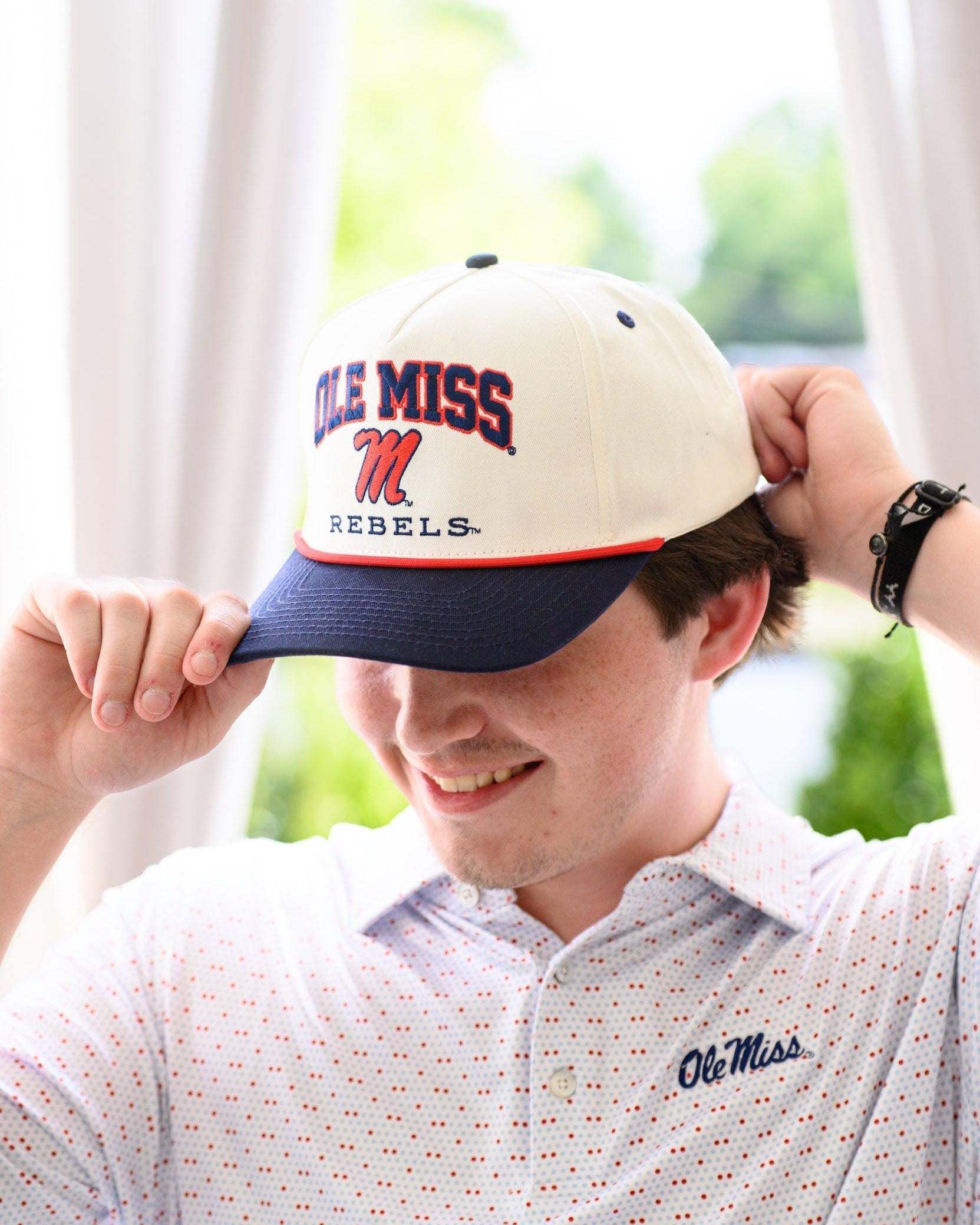 Ole Miss Cream and Navy Hat with embroidered text “Ole Miss Rebels” surrounding the Script M Logo