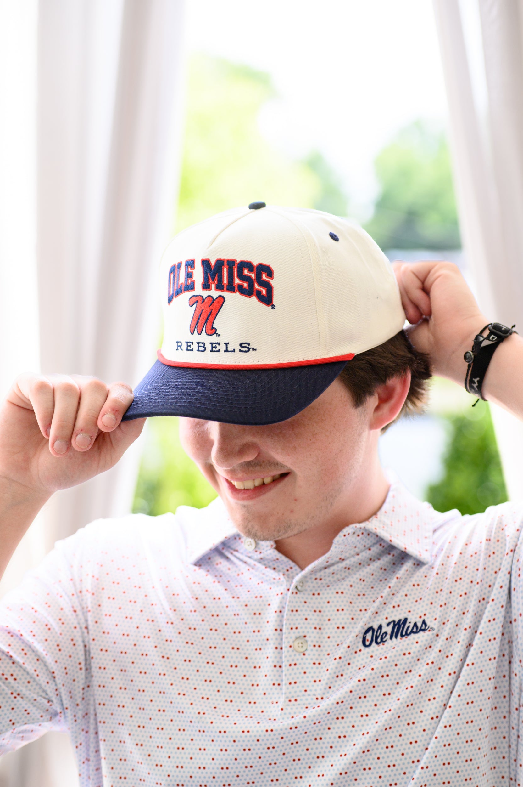 Ole Miss Cream and Navy Hat with embroidered text “Ole Miss Rebels” surrounding the Script M Logo