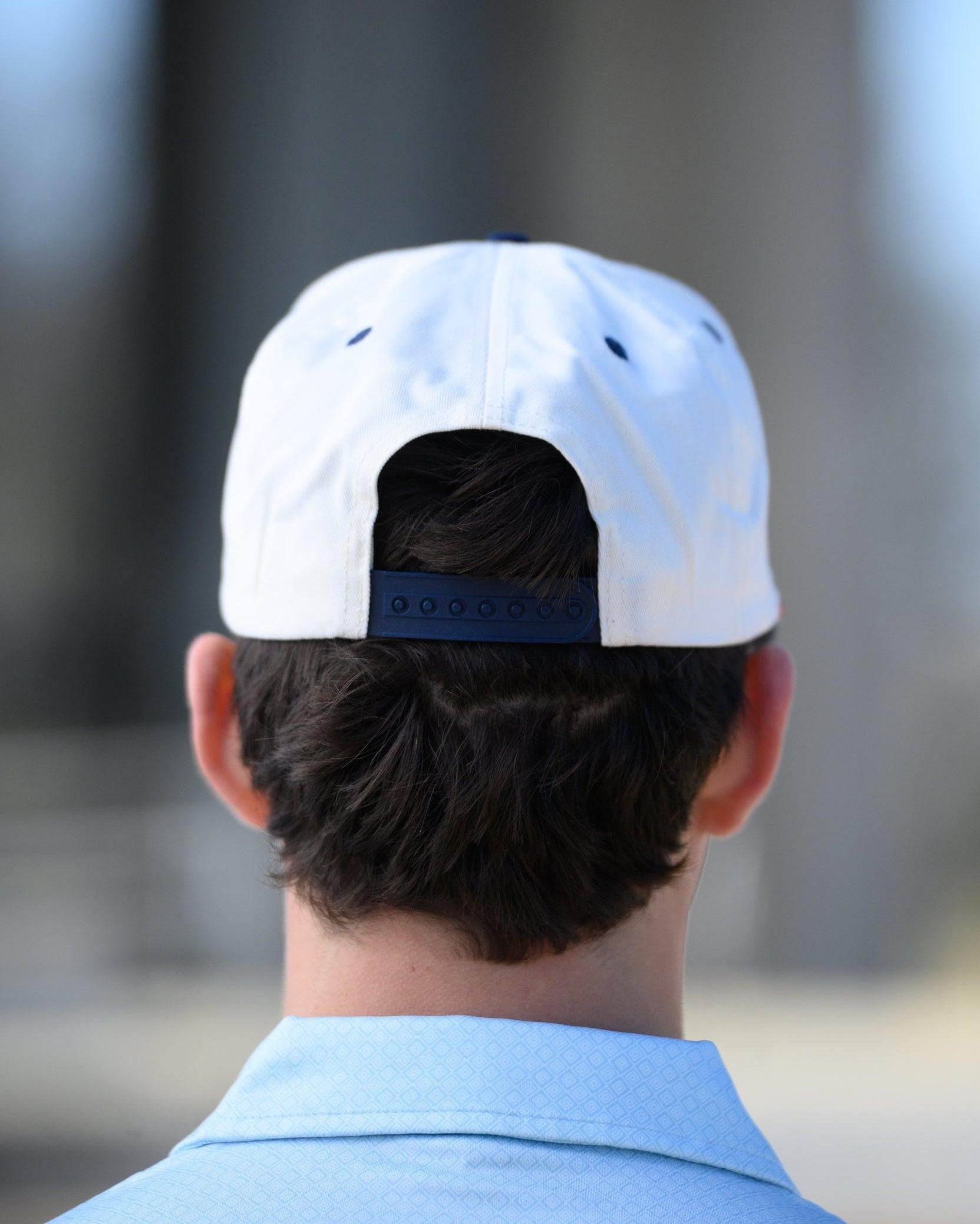 Ole Miss Cream and Navy Hat with embroidered text “Ole Miss Rebels” surrounding the Script M Logo snapack hat