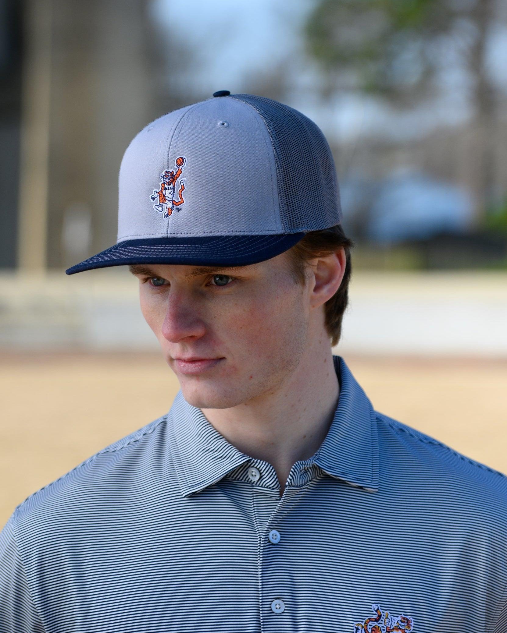 Auburn University Grey and Navy Trucker Hat with the Original Aubie basketball logo on the front, featuring a gray crown and black visor.