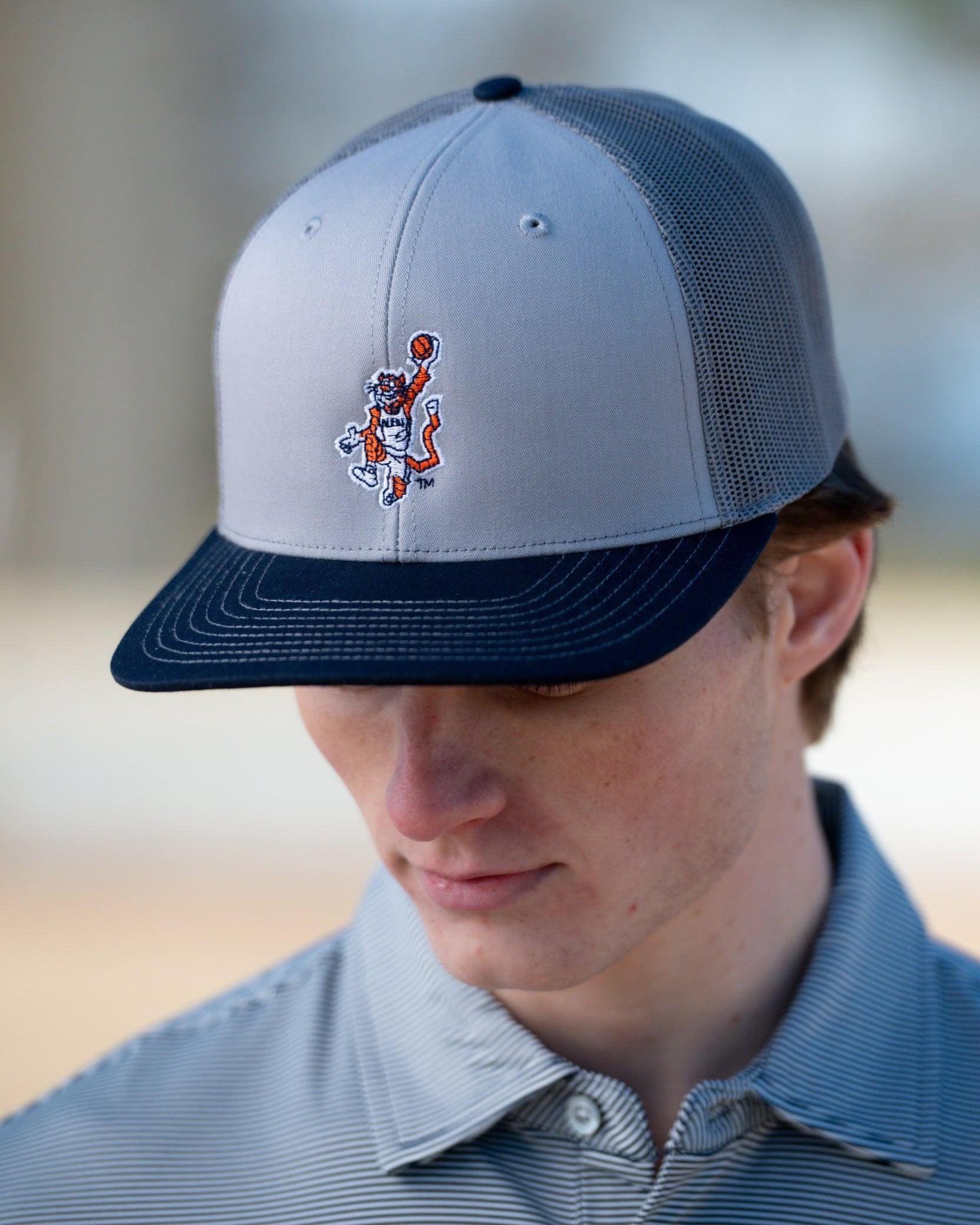 Auburn University Grey and Navy Trucker Hat with the Original Aubie basketball logo on the front, featuring a gray crown and black visor.