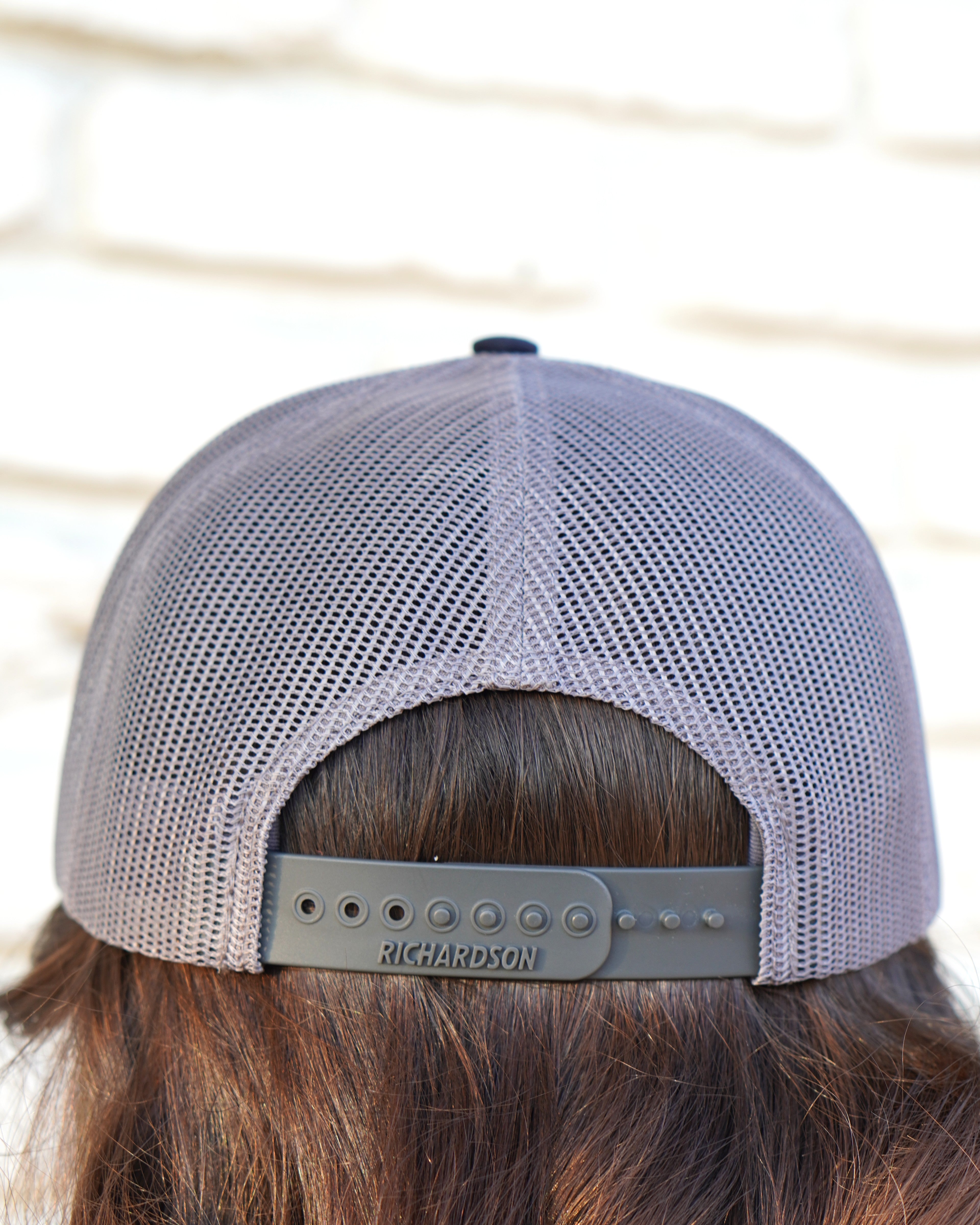 Auburn University Grey and Navy Trucker Hat with the Original Aubie basketball logo on the front, featuring a gray crown and black visor.