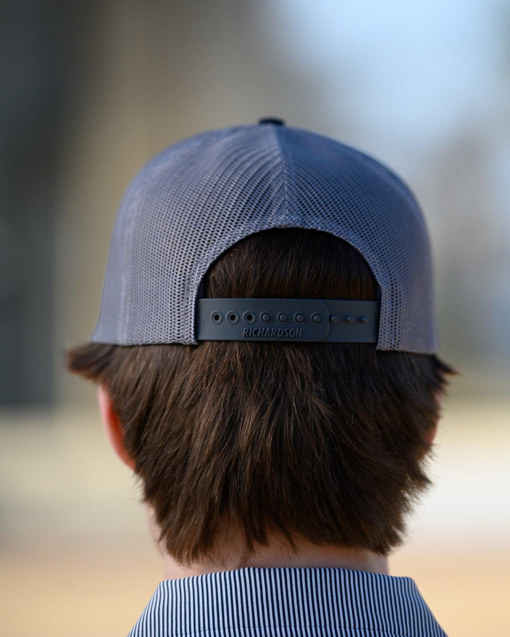 Auburn University Grey and Navy Trucker Hat with the Original Aubie basketball logo on the front, featuring a gray crown and black visor.
