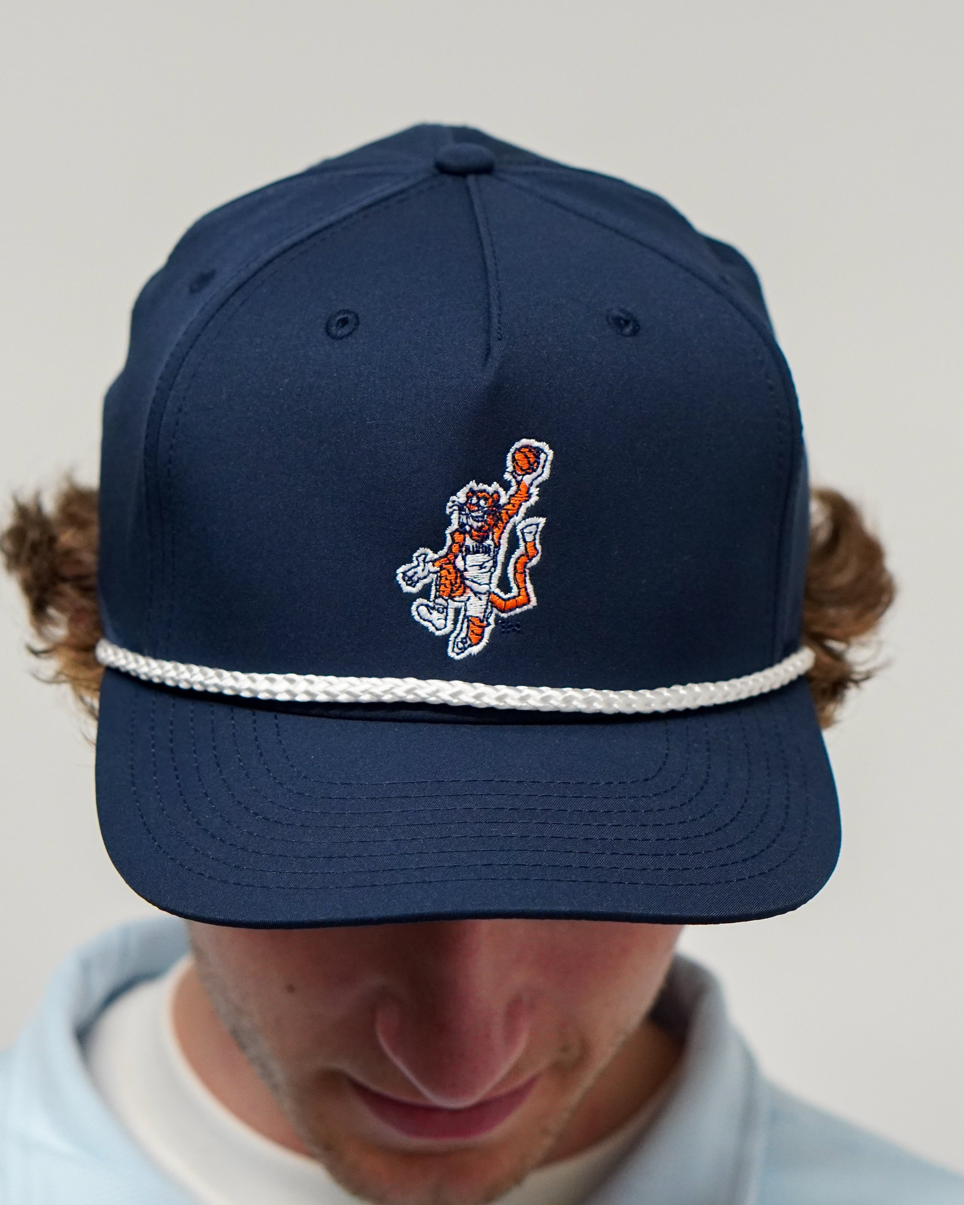 Auburn University Navy Hat with a White Rope and a patch or the Original Aubie dunking a Basketball