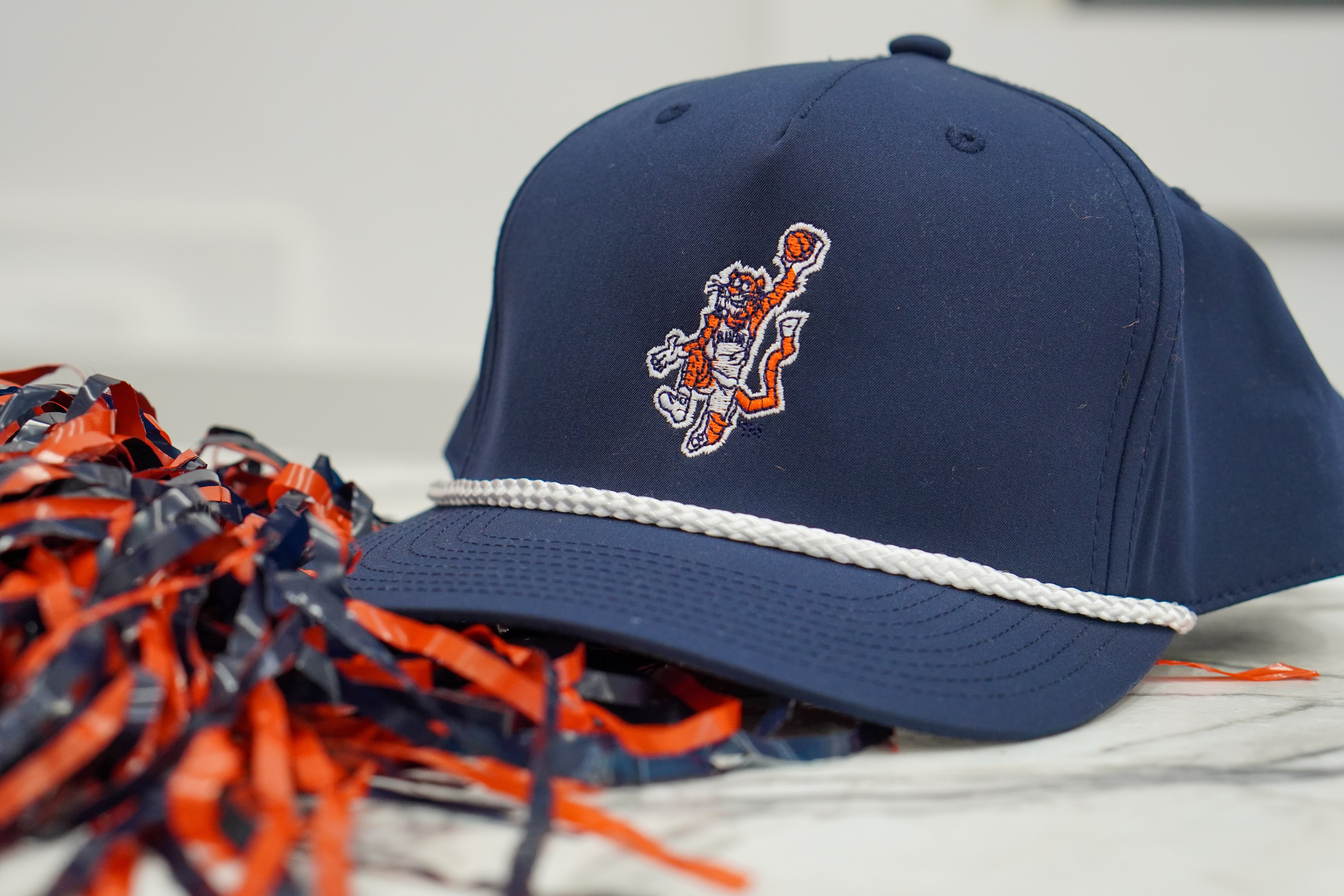 Auburn University Navy Hat with a White Rope and a patch or the Original Aubie dunking a Basketball
