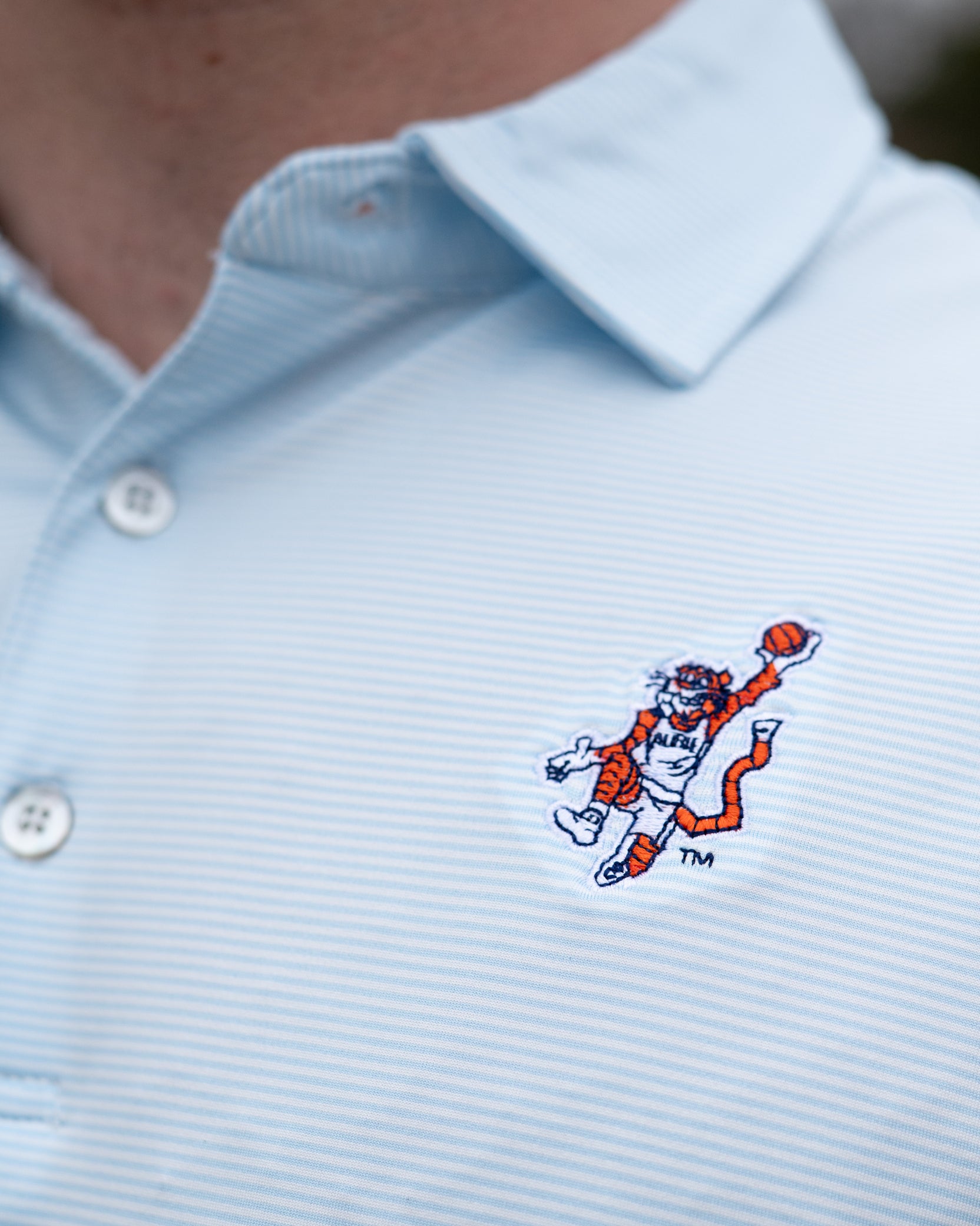 Auburn University Light Blue Men’s Stripe Polo with the Original Aubie Basketball Logo embroidery