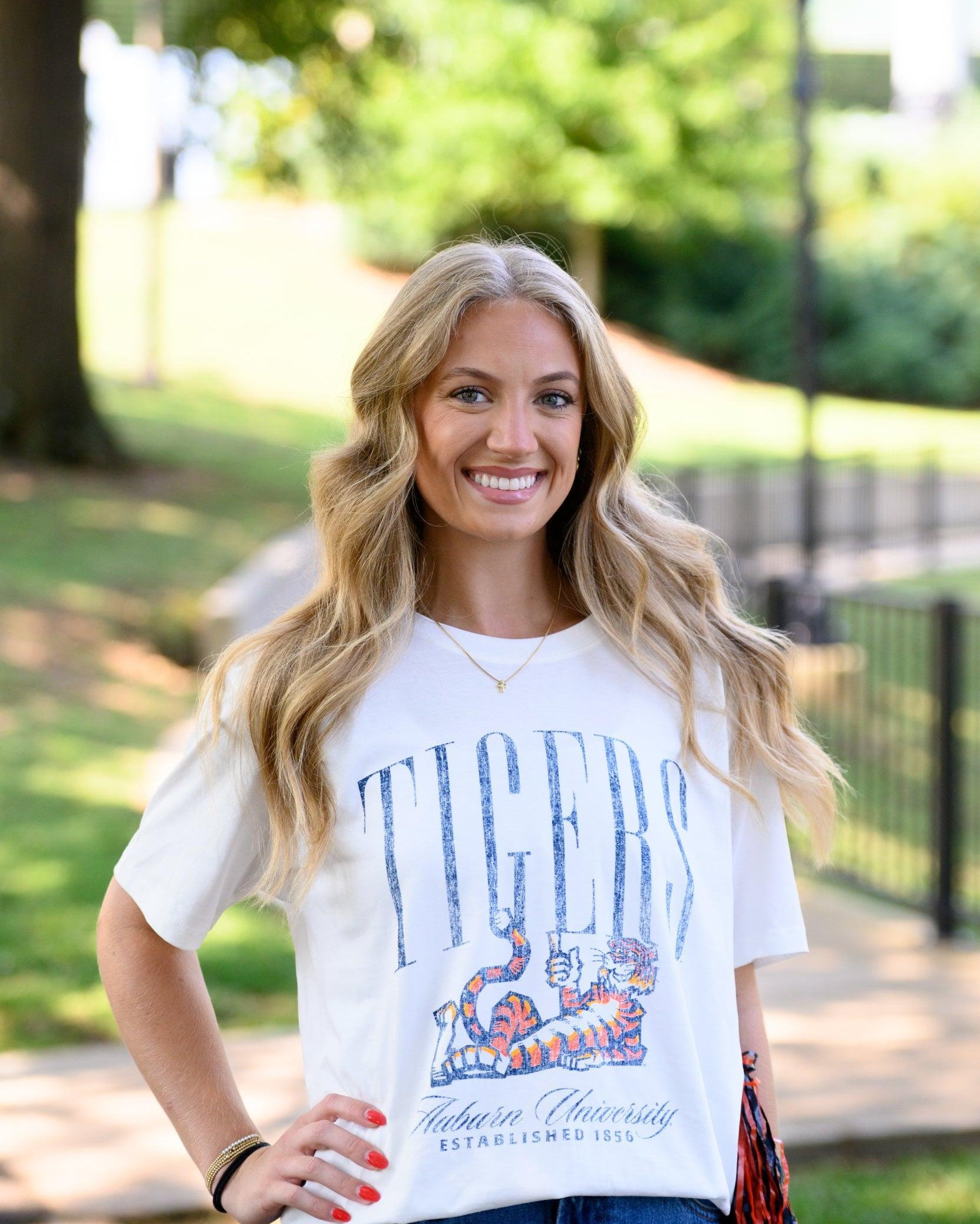 Auburn University Ivory T-Shirt with navy text “Tigers” above Aubie laying down