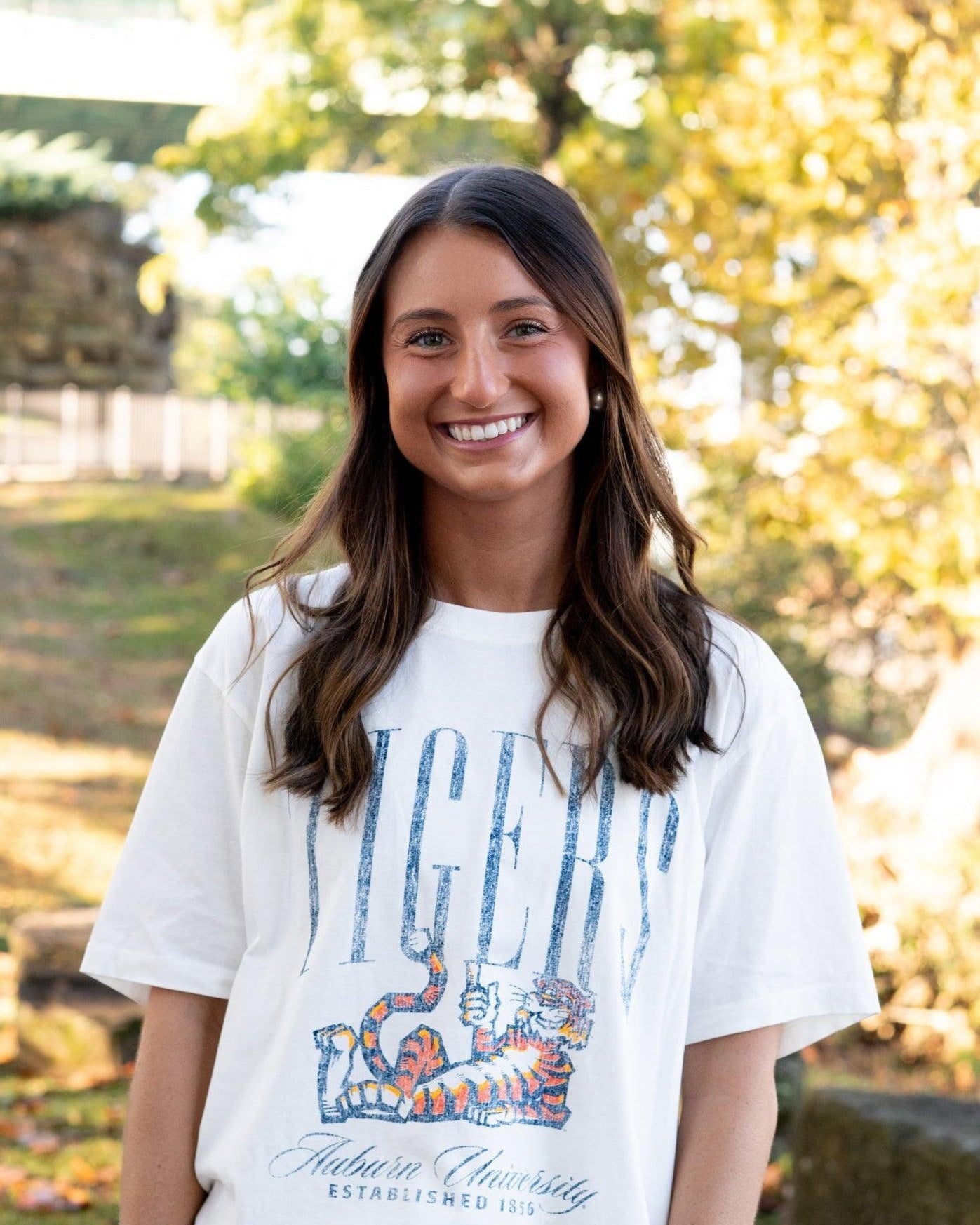 Auburn University Ivory T-Shirt with navy text “Tigers” above Aubie laying down