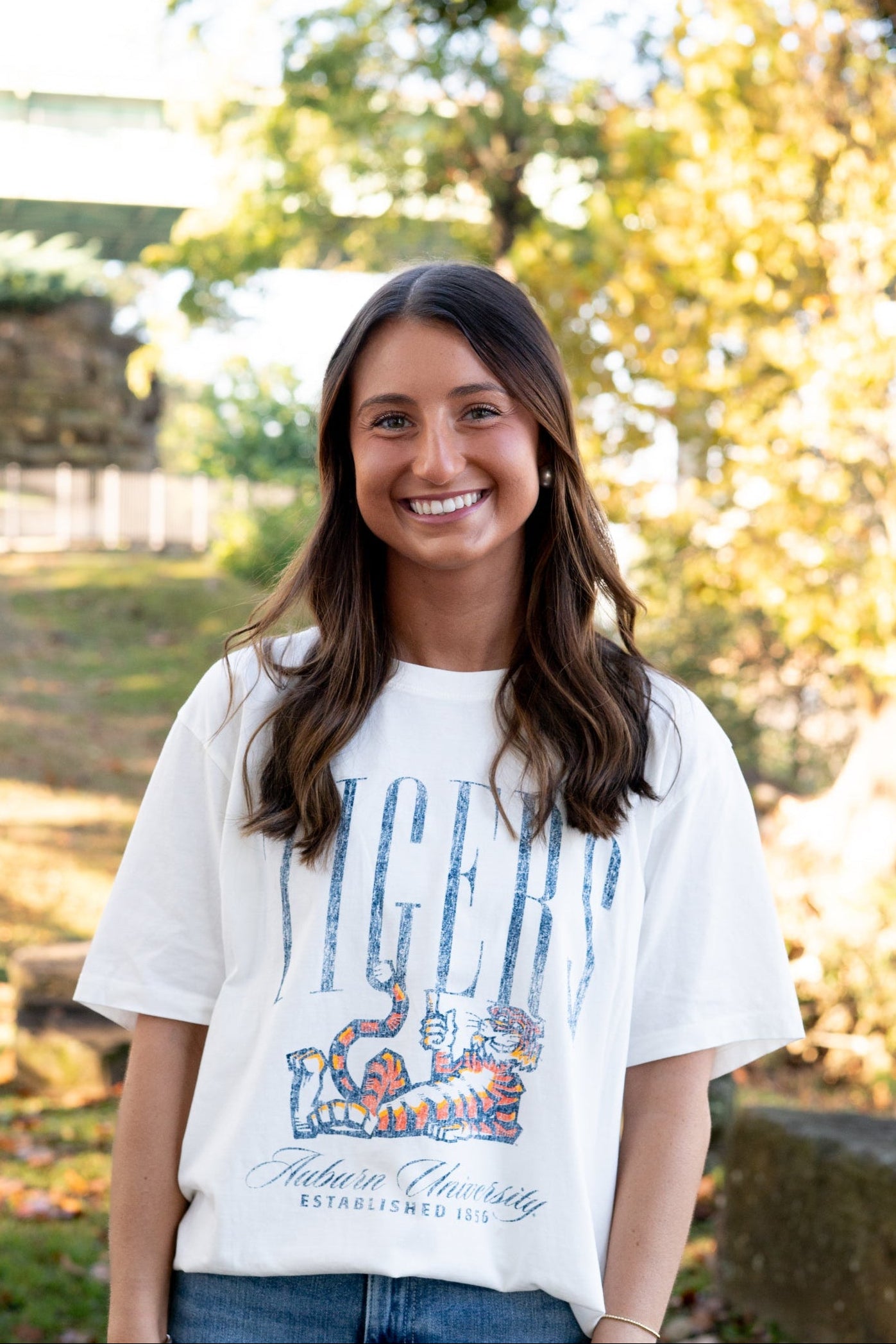 Auburn University Ivory T-Shirt with navy text “Tigers” above Aubie laying down