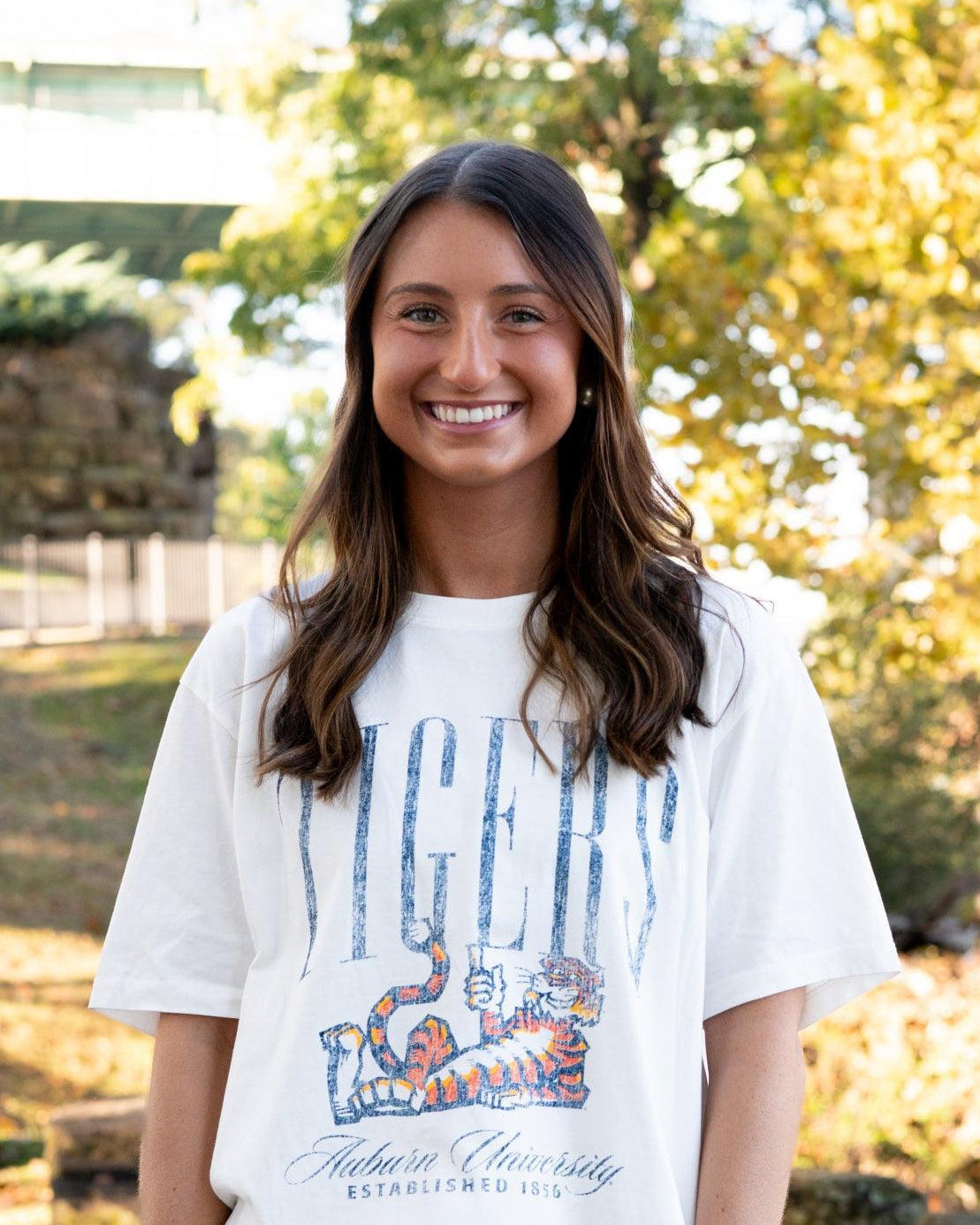Auburn University Ivory T-Shirt with navy text “Tigers” above Aubie laying down