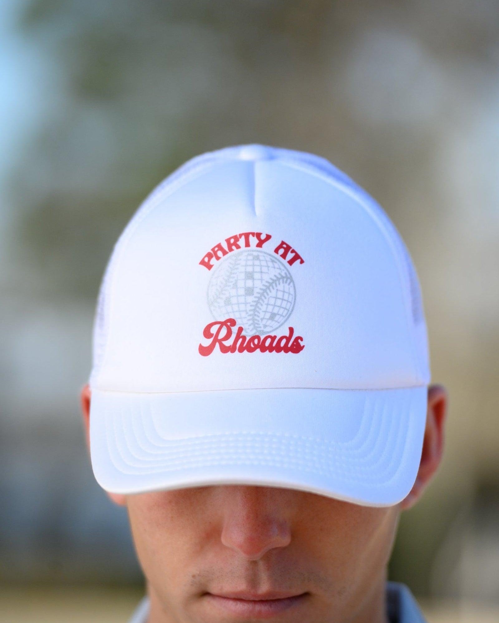 University of Alabama White Trucker Hat with Red “Party At Rhoads” text and a disco softball design in silver.