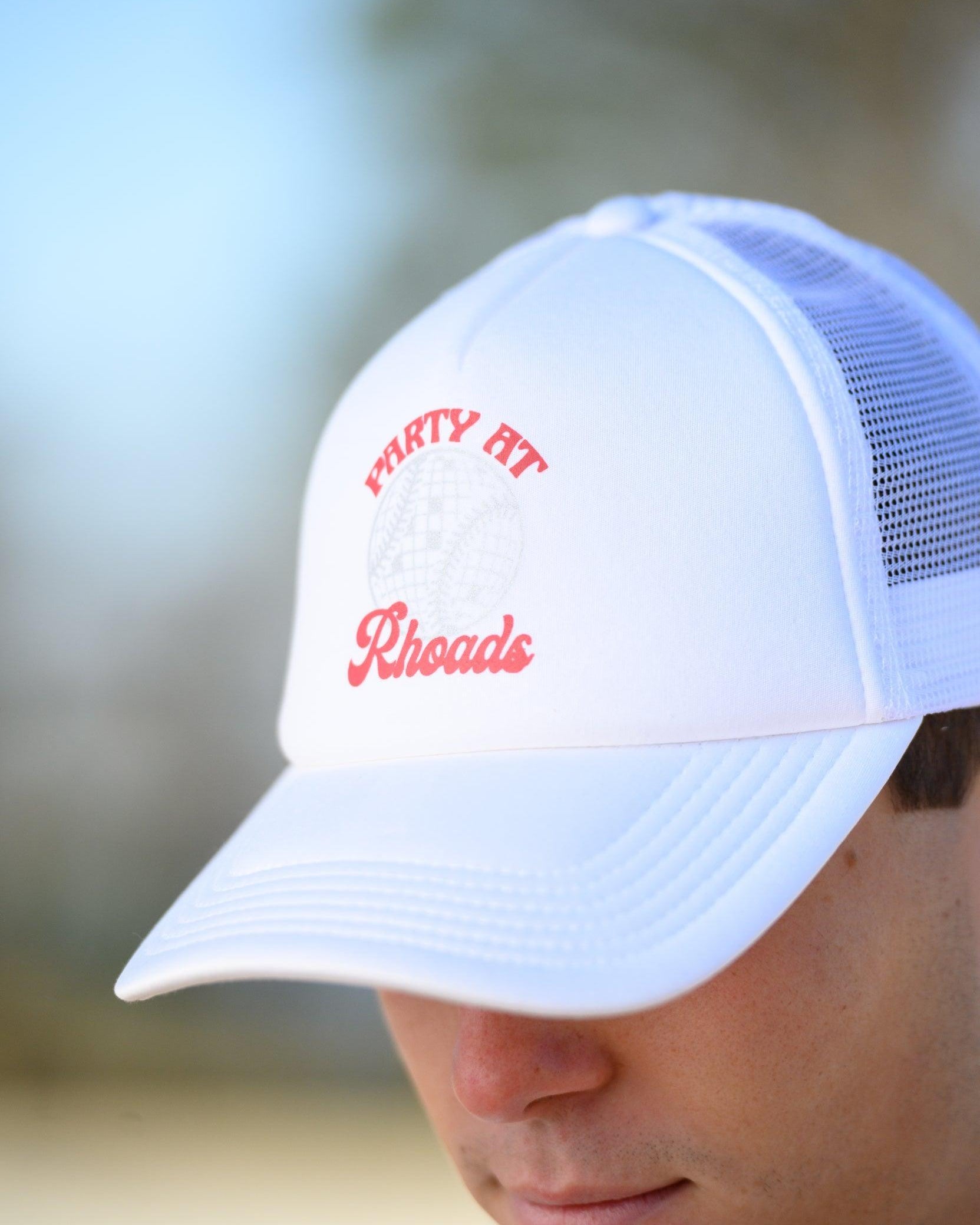 University of Alabama White Trucker Hat with Red “Party At Rhoads” text and a disco softball design in silver.