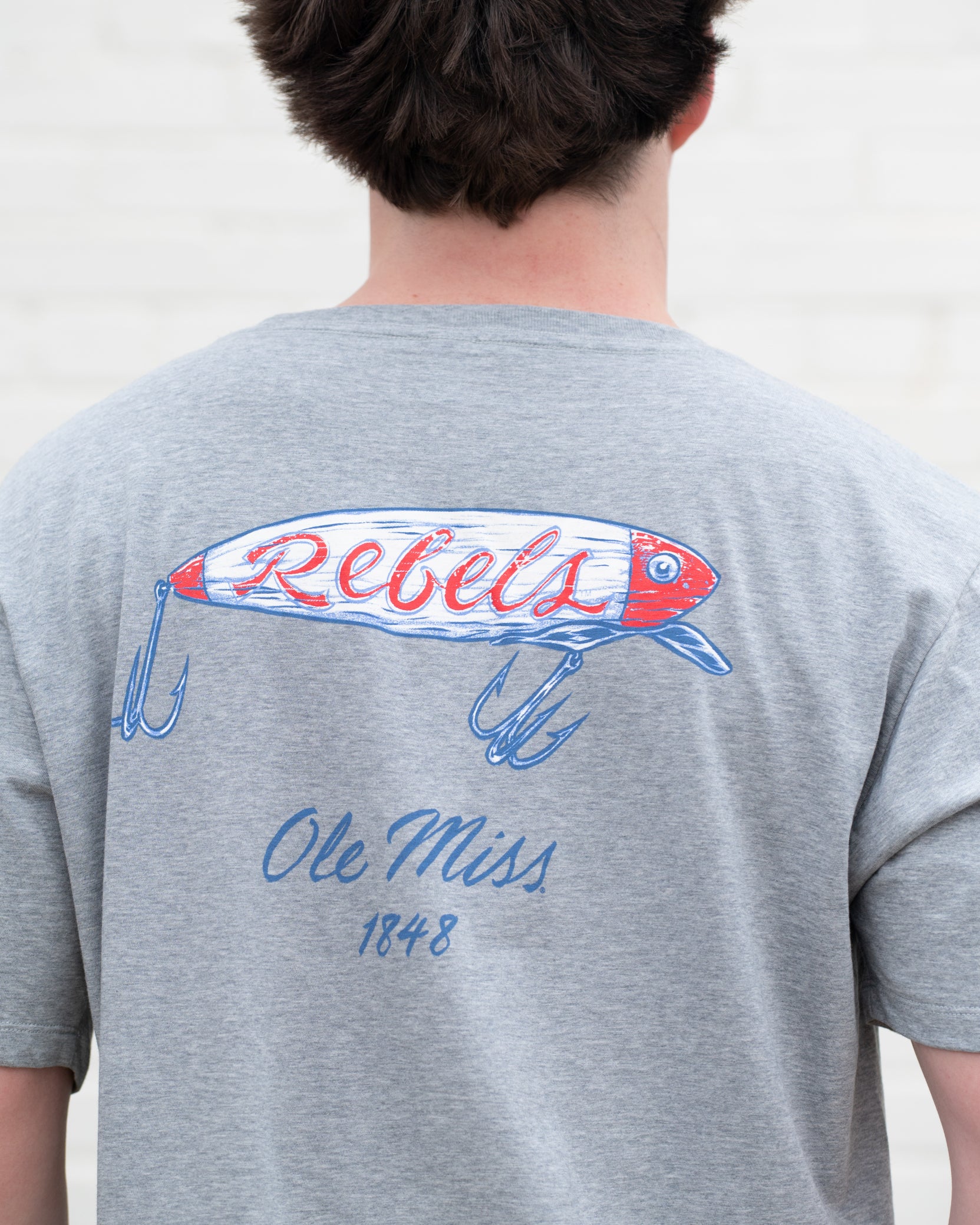 Ole Miss Grey T-Shirt with a fishing lure with Red script “Rebels”