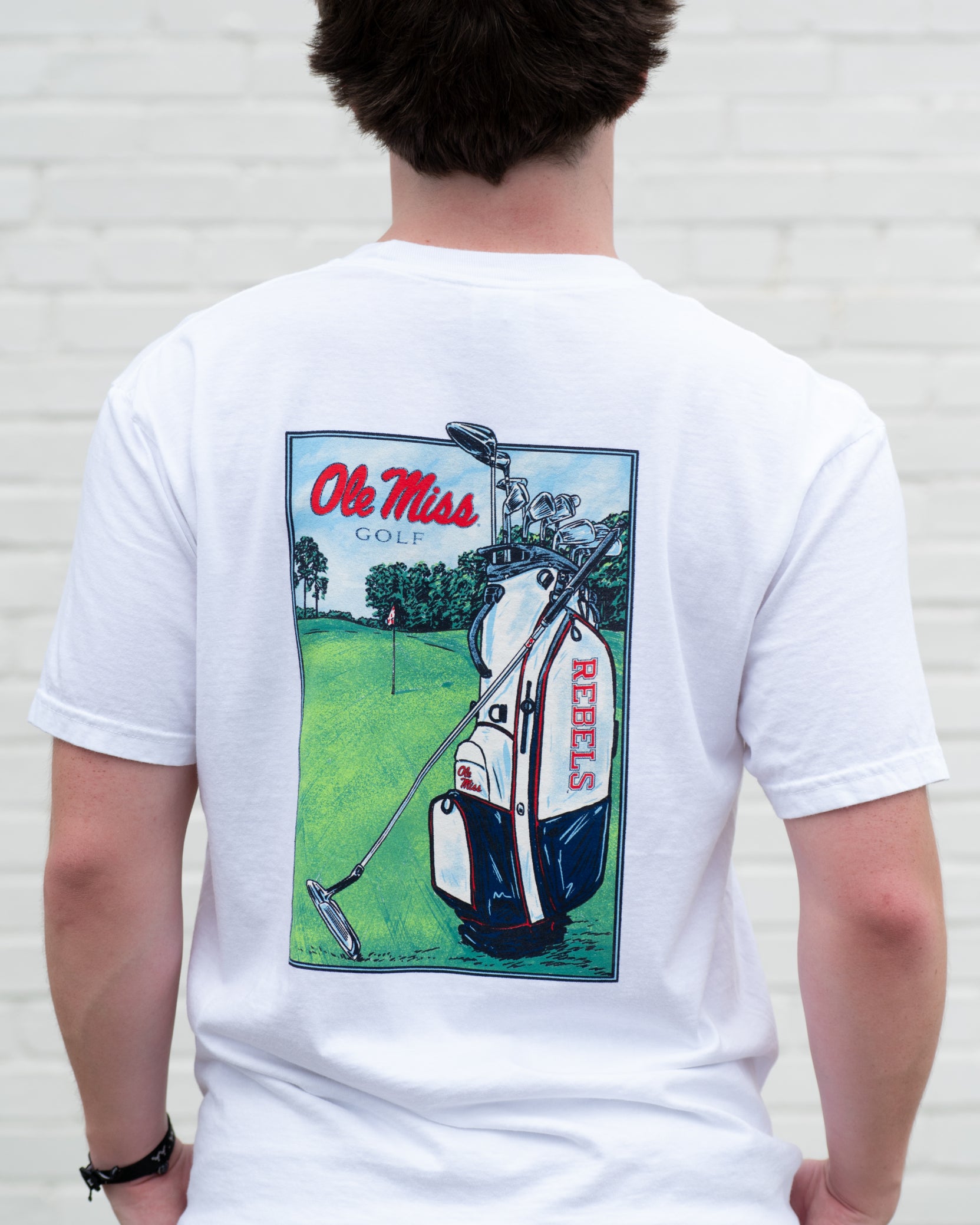 Ole Miss White T-Shirt with an image of a golf club carrying bag with the Rebels Logo