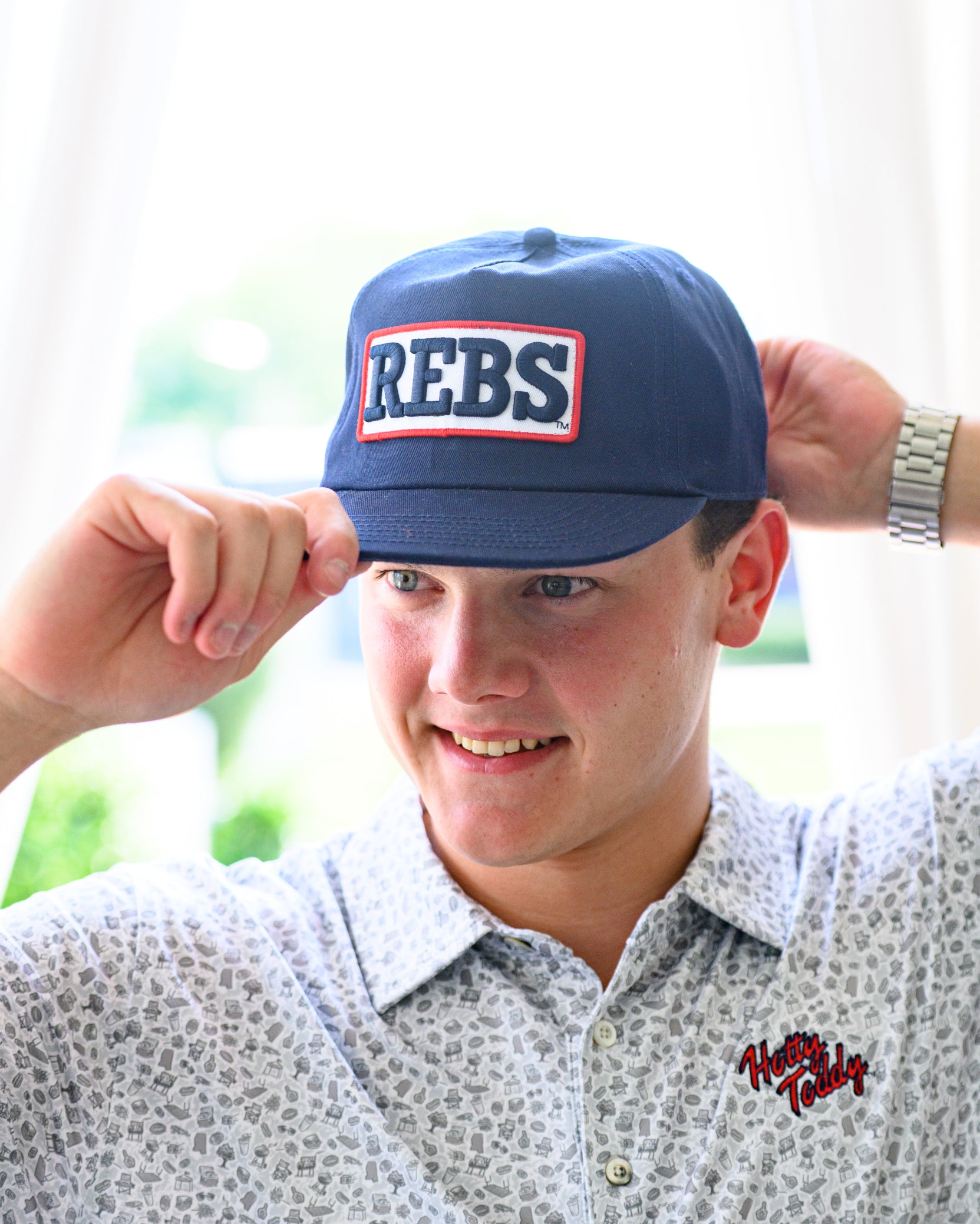 Ole Miss Navy Snapback Hat featuring a White patch with Navy “REBS” embroidery