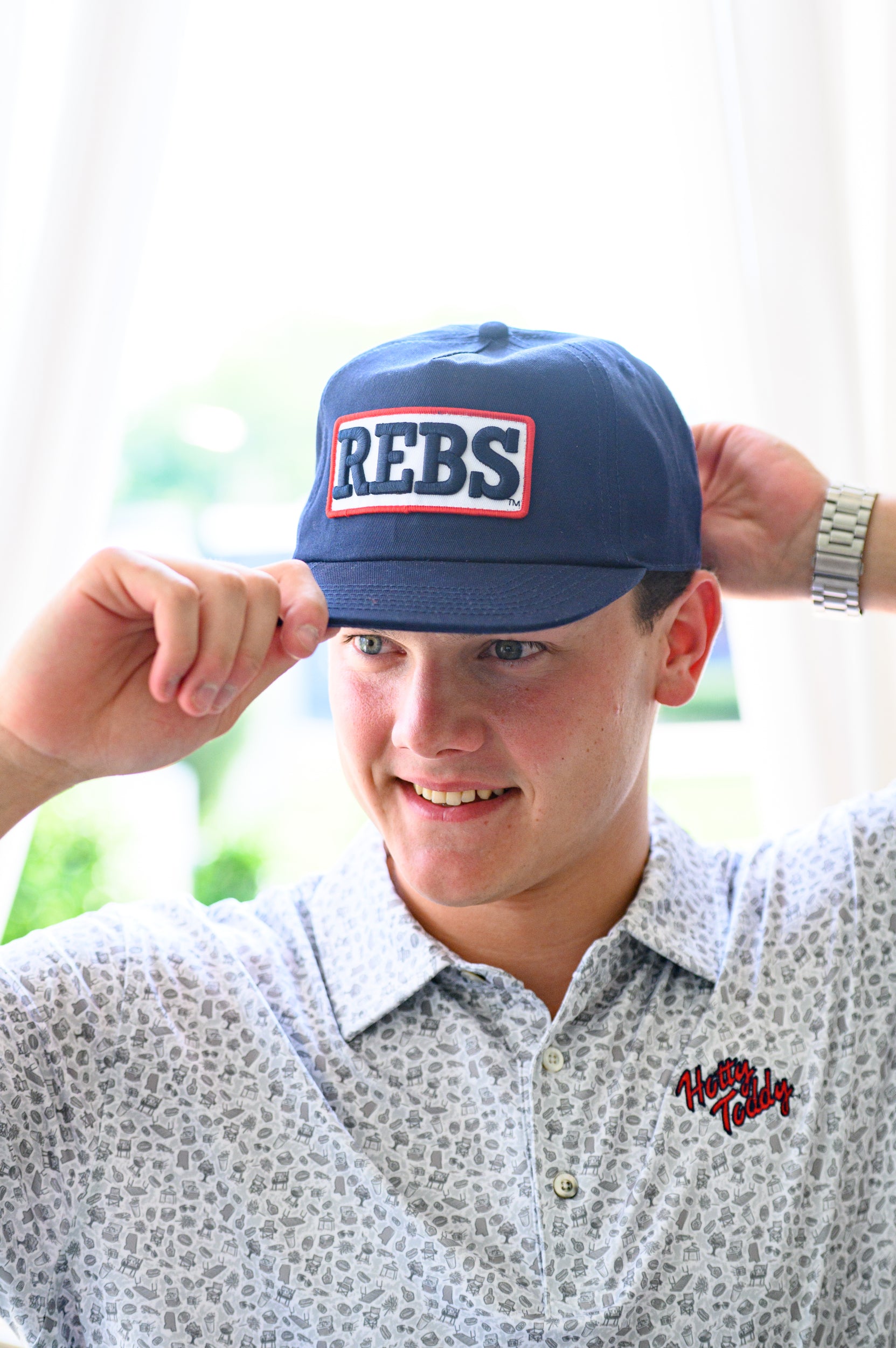 Ole Miss Navy Snapback Hat featuring a White patch with Navy “REBS” embroidery