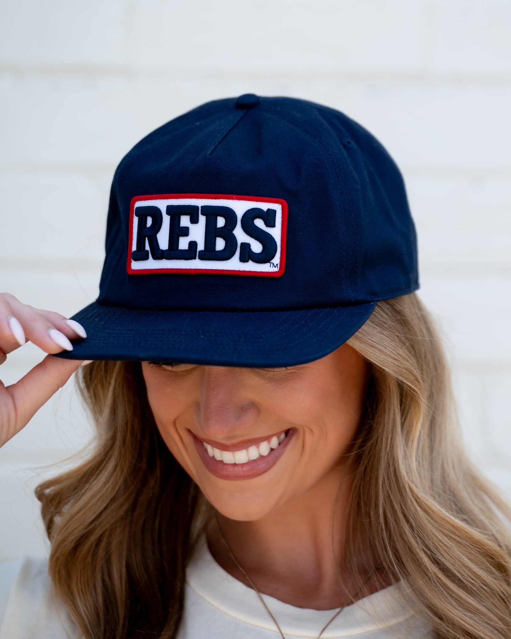 Ole Miss Navy Snapback Hat featuring a White patch with Navy “REBS” embroidery