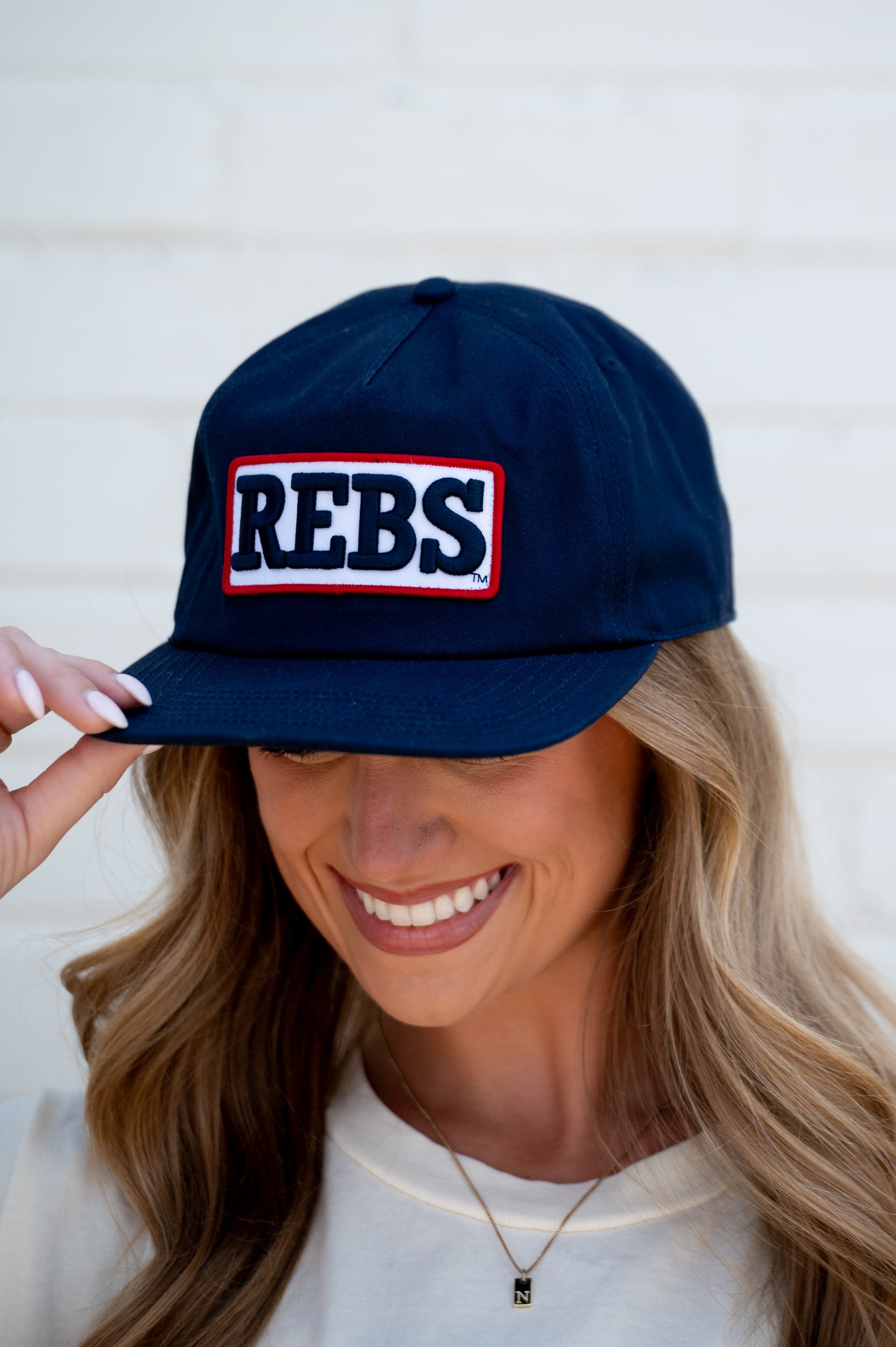 Ole Miss Navy Snapback Hat featuring a White patch with Navy “REBS” embroidery