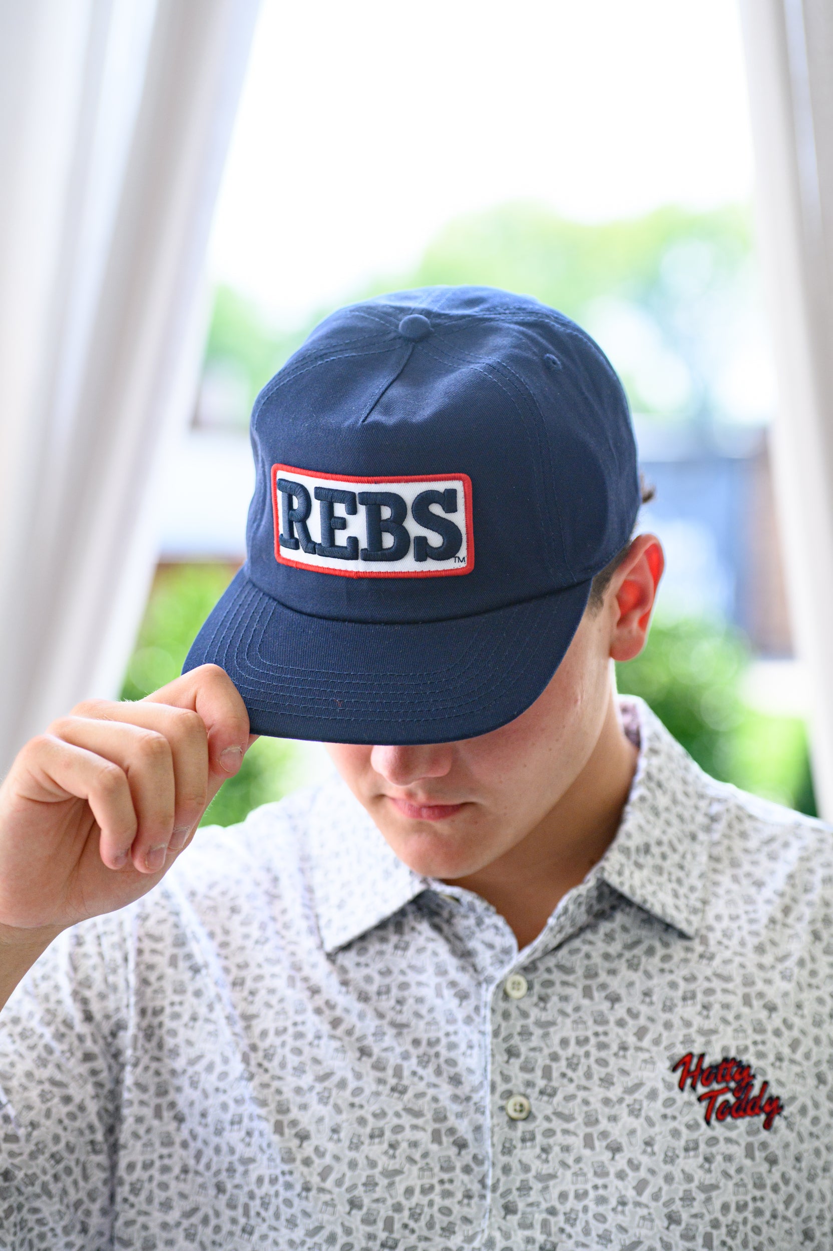 Ole Miss Navy Snapback Hat featuring a White patch with Navy “REBS” embroidery
