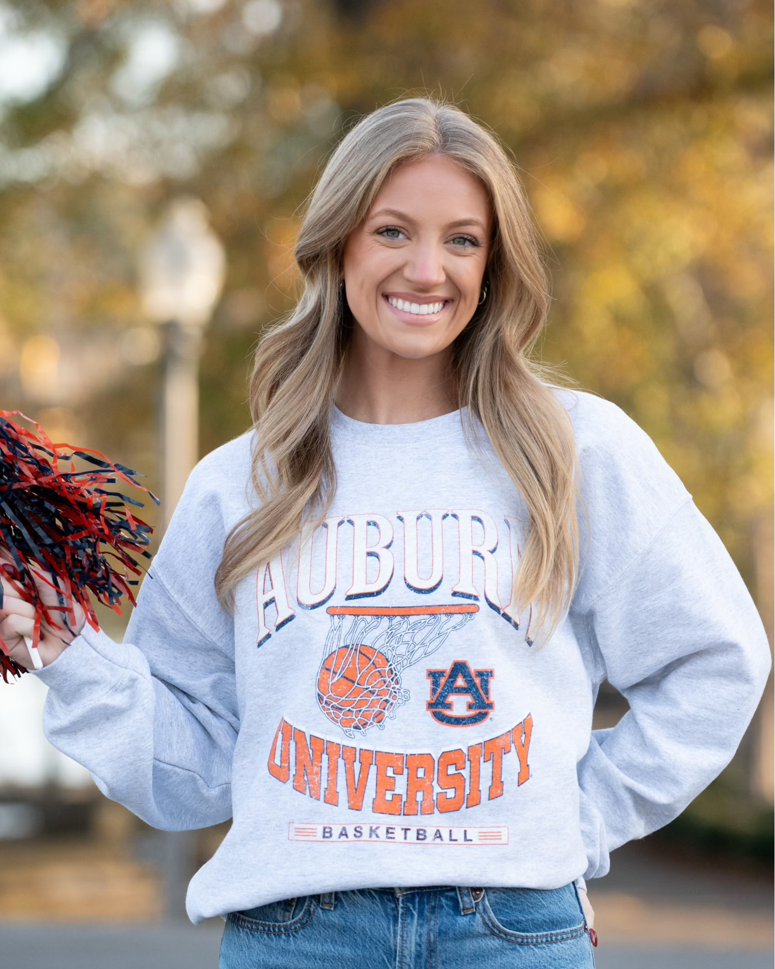 Auburn University Light Grey Heather Sweatshirt with a basketball landing in a hoop between text “Auburn” and “University Basketball”