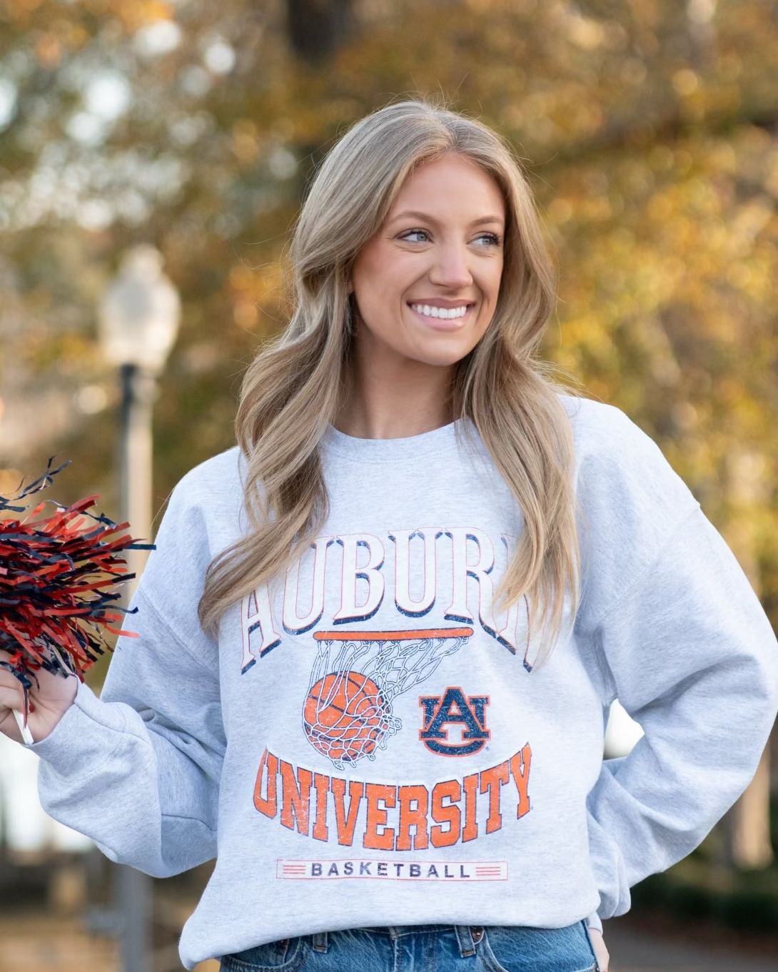 Auburn University Light Grey Heather Sweatshirt with a basketball landing in a hoop between text “Auburn” and “University Basketball”