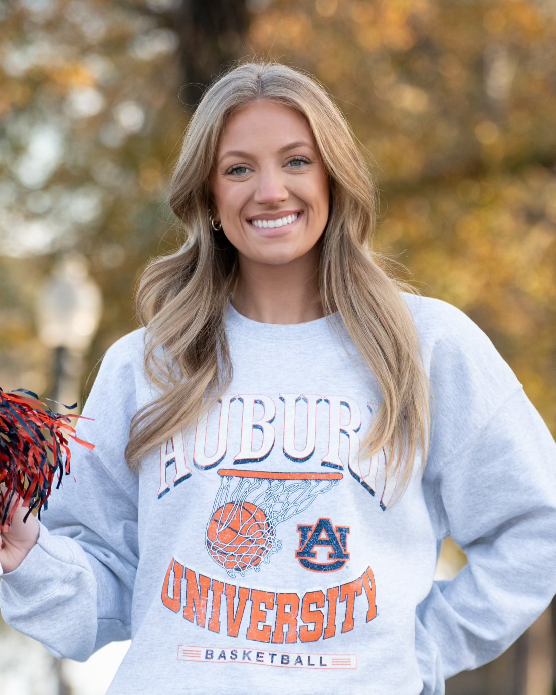 Auburn University Light Grey Heather Sweatshirt with a basketball landing in a hoop between text “Auburn” and “University Basketball”