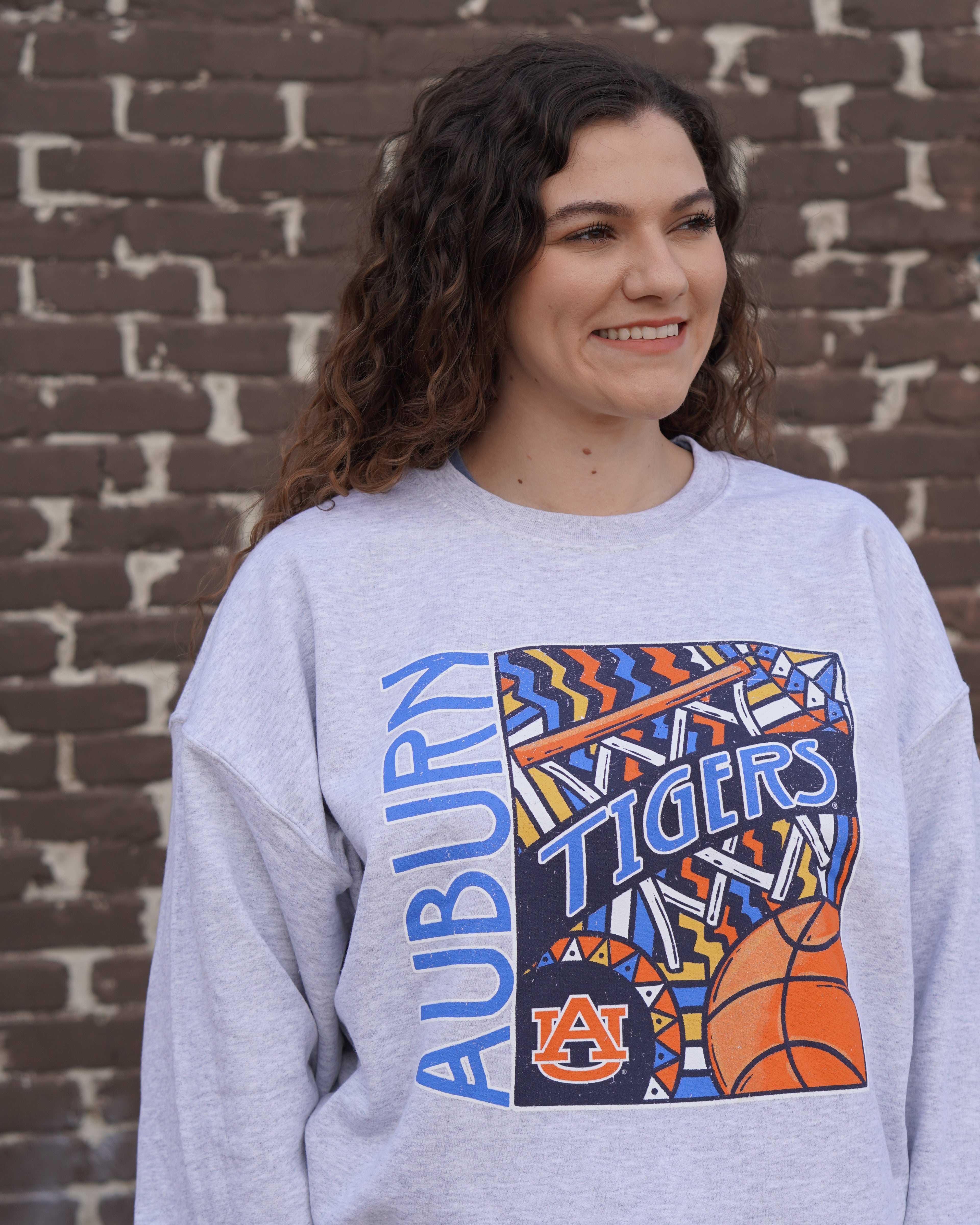 Auburn University Grey Basketball Sweatshirt with a retro graphic design featuring a basketball, a basketball hoop, and Blue text "Tigers"