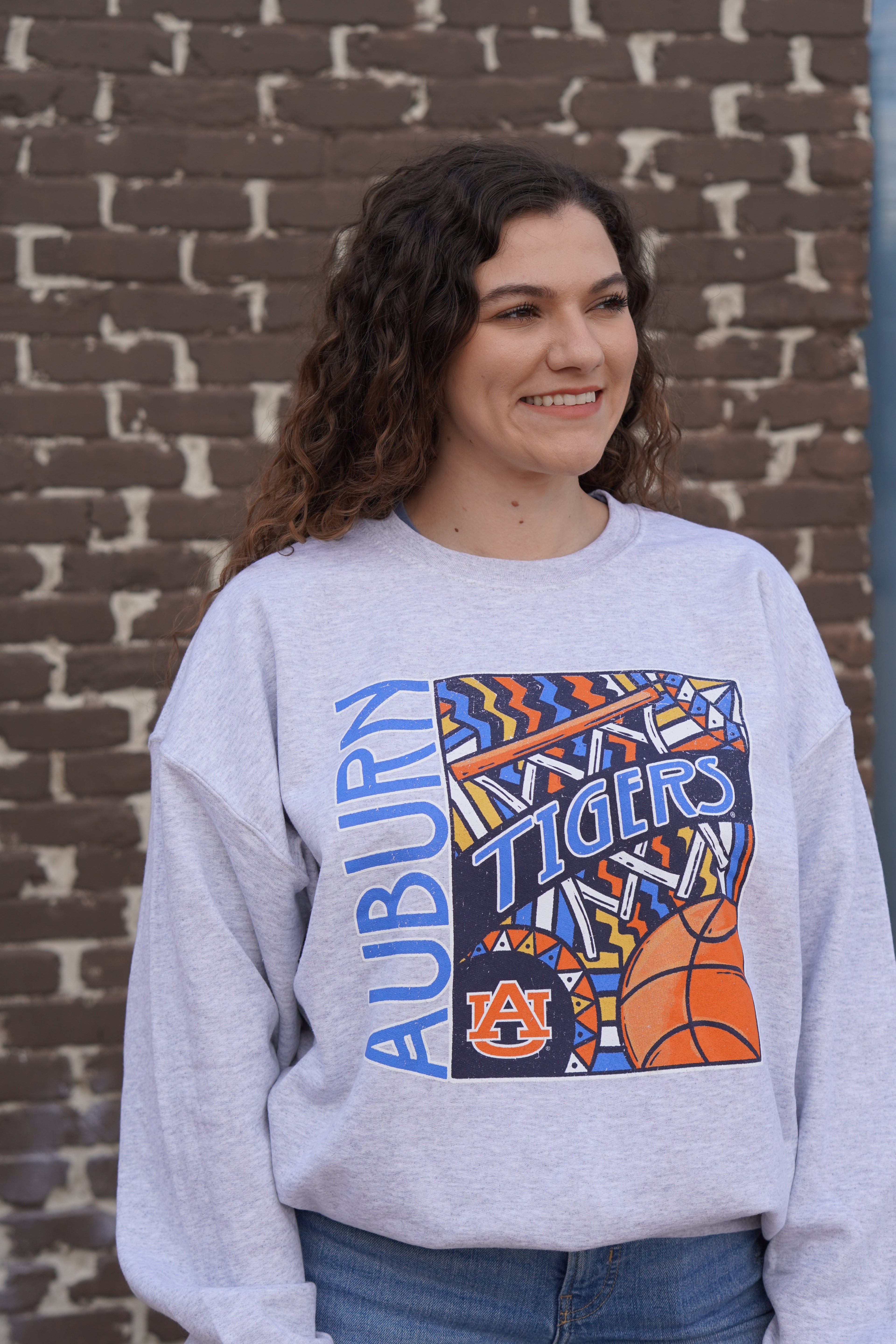 Auburn University Grey Basketball Sweatshirt with a retro graphic design featuring a basketball, a basketball hoop, and Blue text "Tigers"
