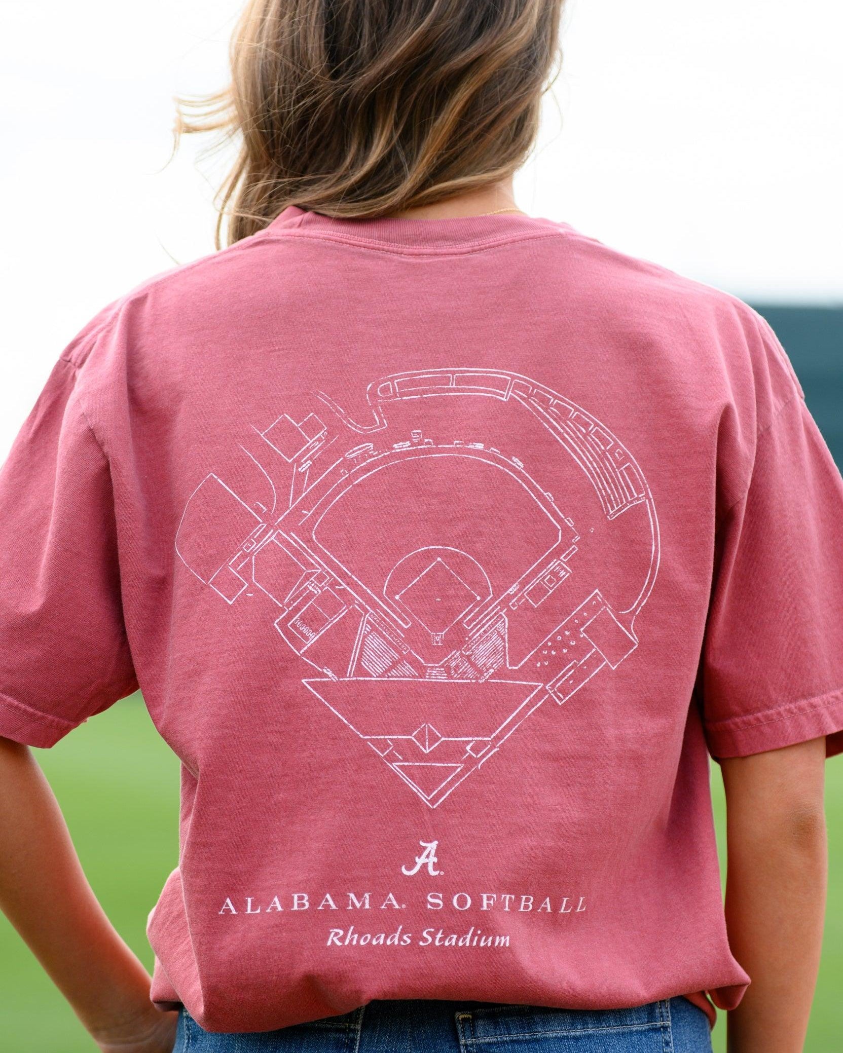 University of Alabama Red Distressed Tee with a White print of the Rhoads Stadium blueprint above text “Alabama Softball”