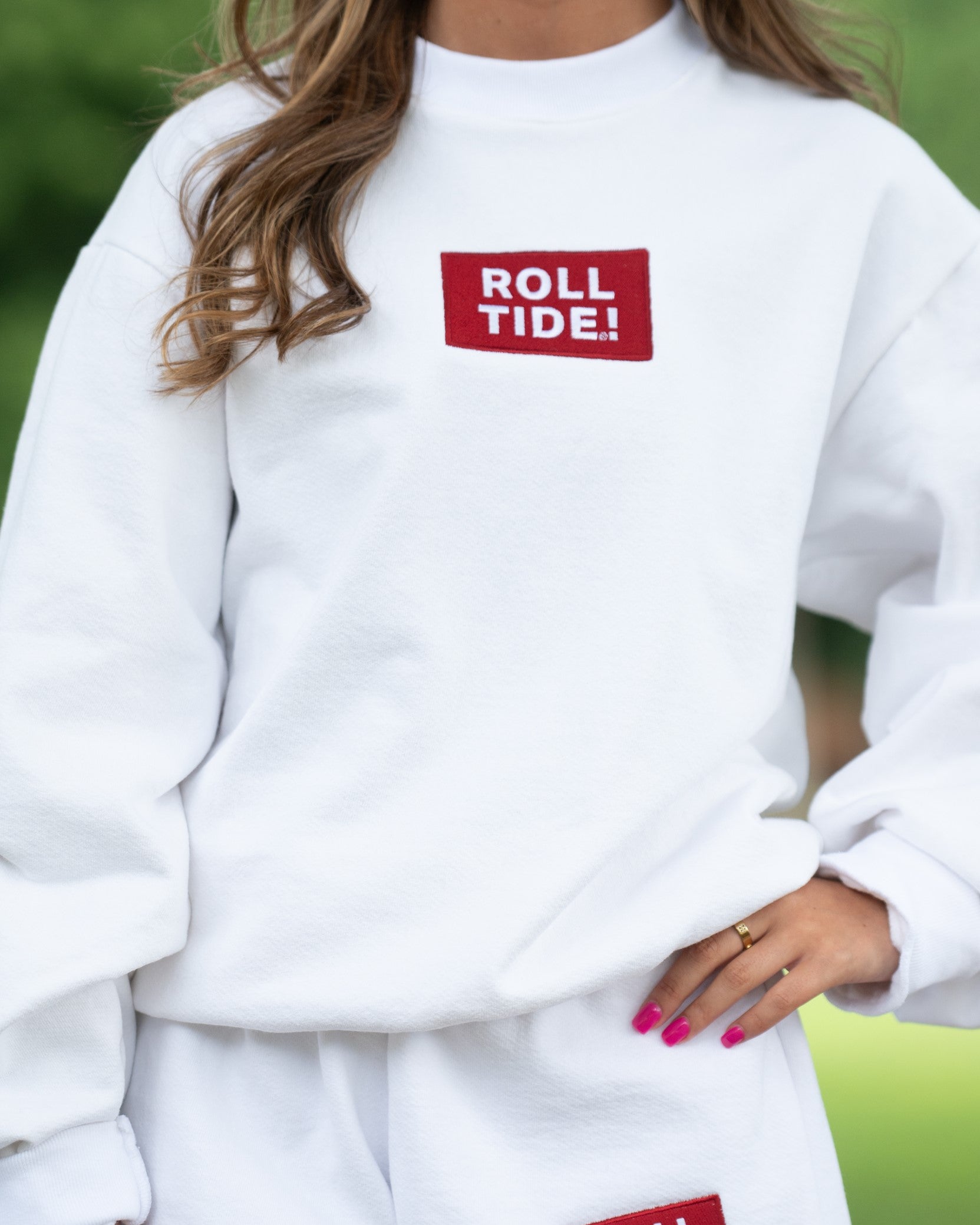 University of Alabama White Roll Tide Sweatshirt featuring a Red and White embroidered patch with text "Roll Tide!"