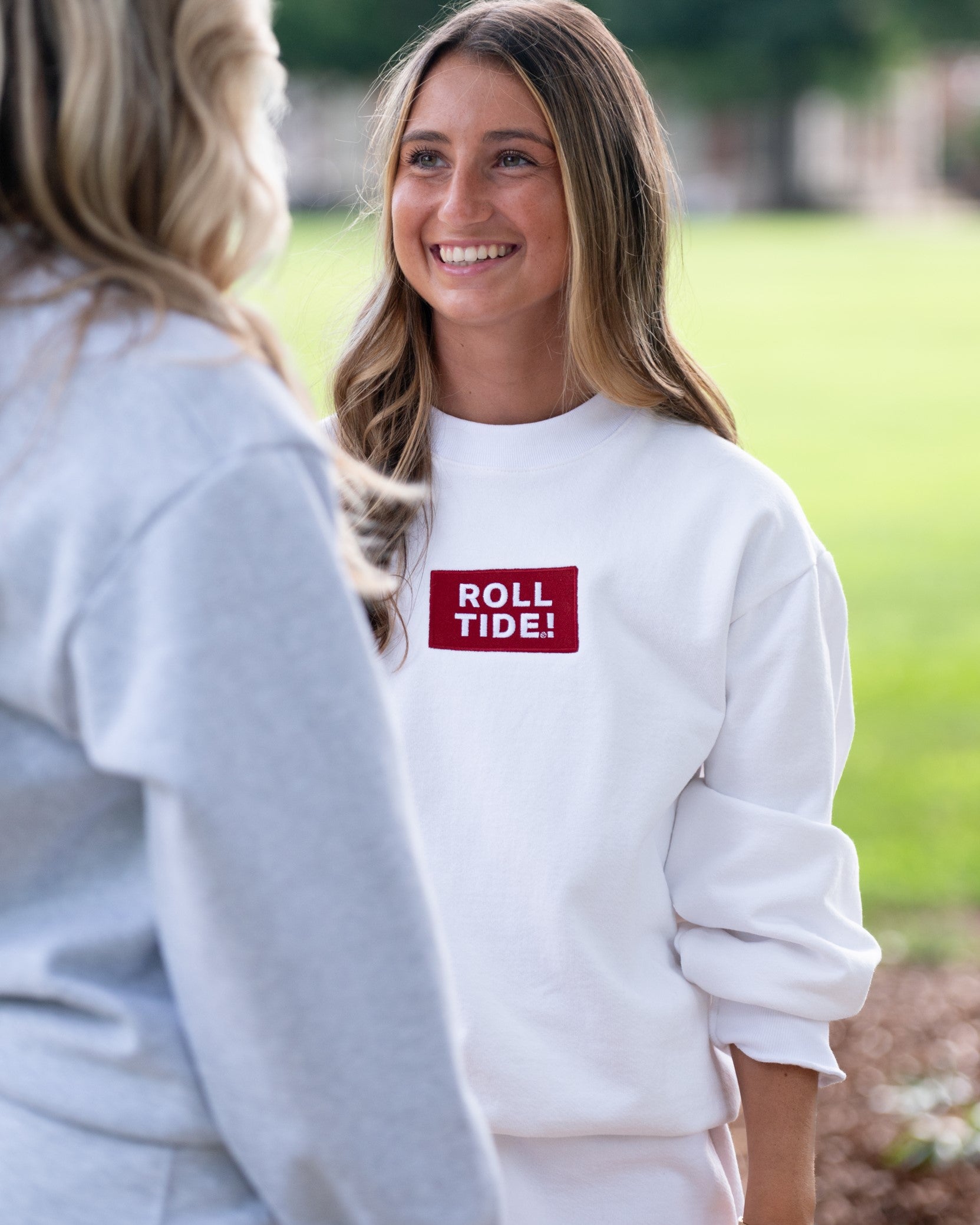 University of Alabama White Roll Tide Sweatshirt featuring a Red and White embroidered patch with text "Roll Tide!"