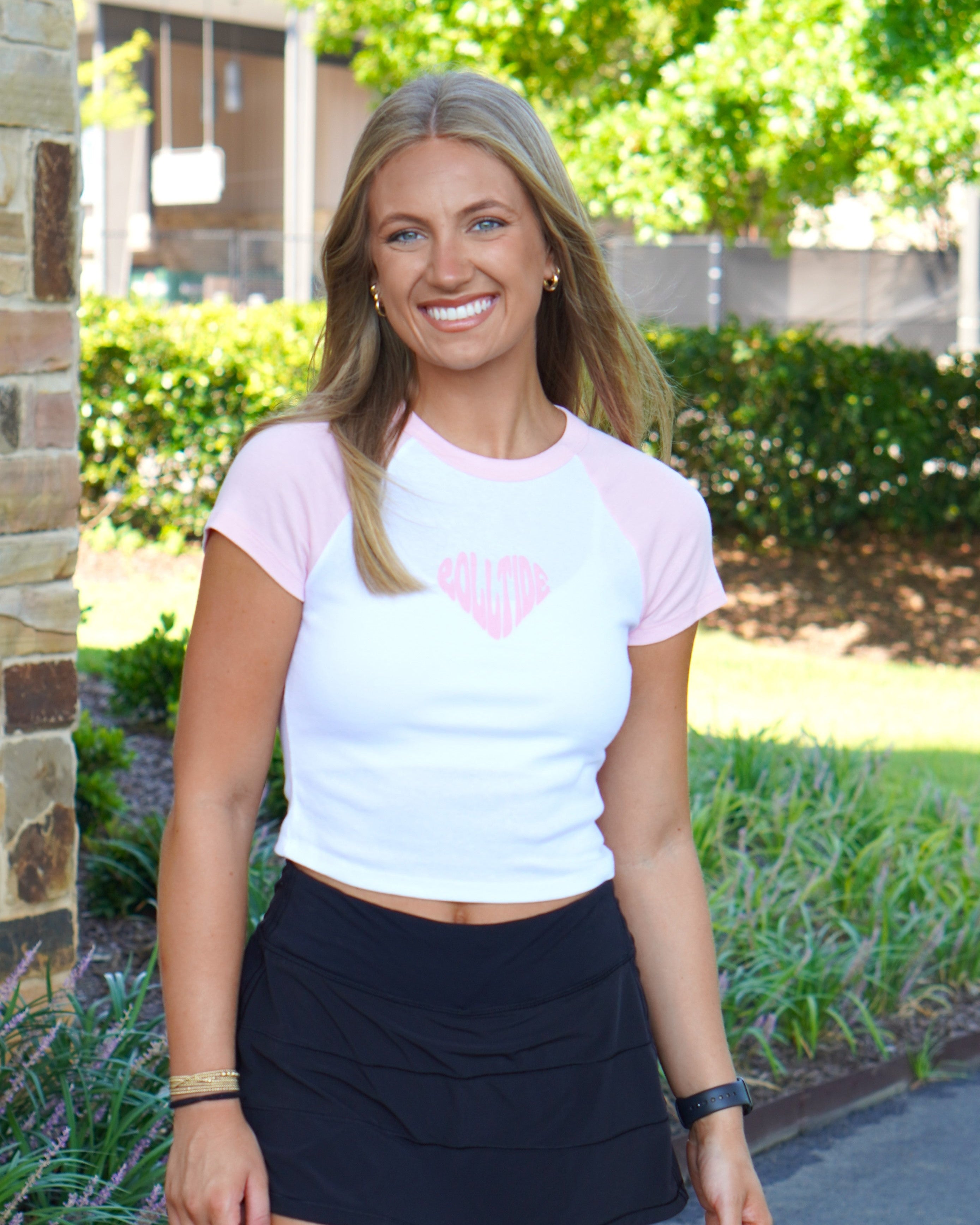 University of Alabama Pink and White Baby Tee with a Pink heart made of the text "Roll Tide"