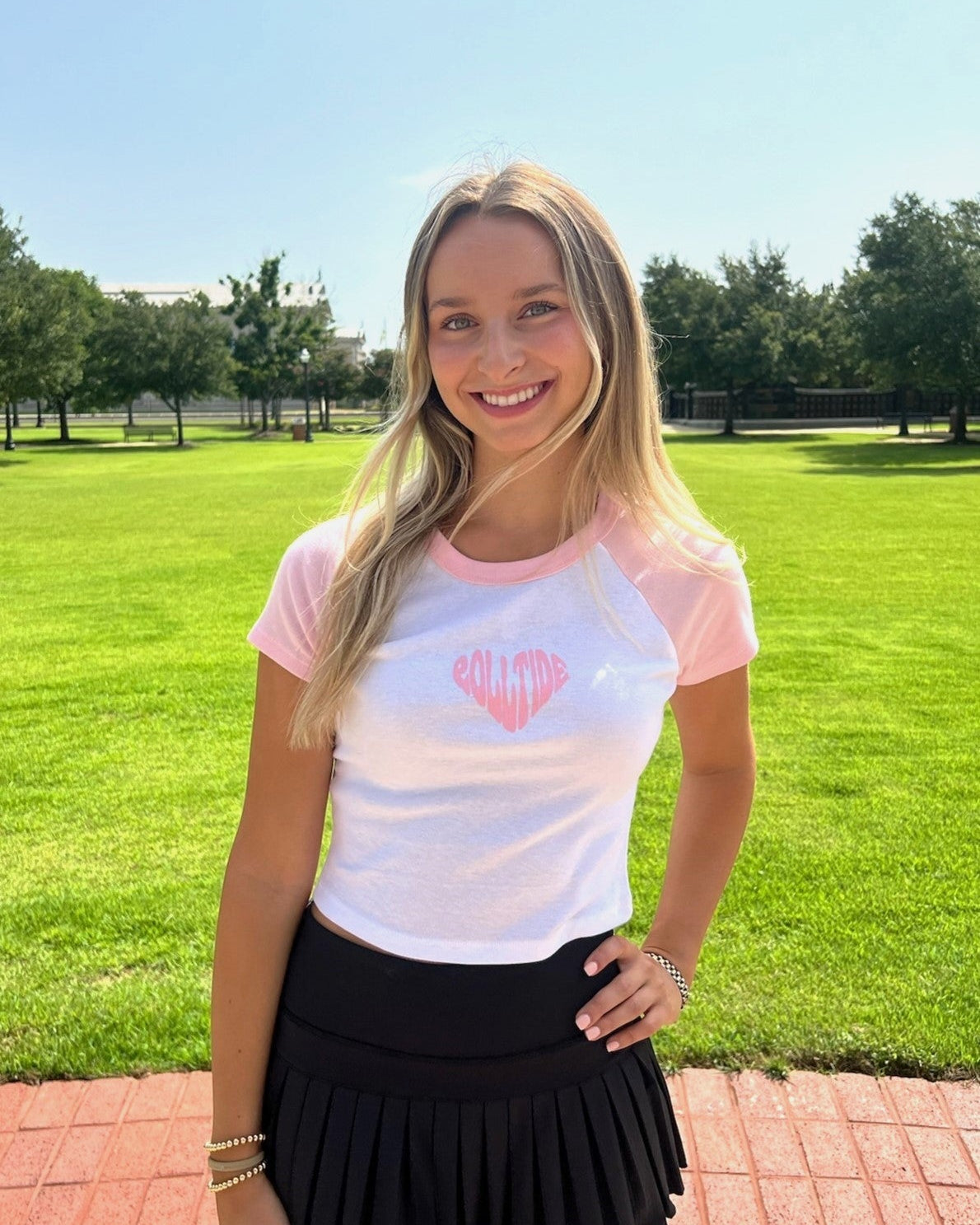 University of Alabama Pink and White Baby Tee with a Pink heart made of the text "Roll Tide"