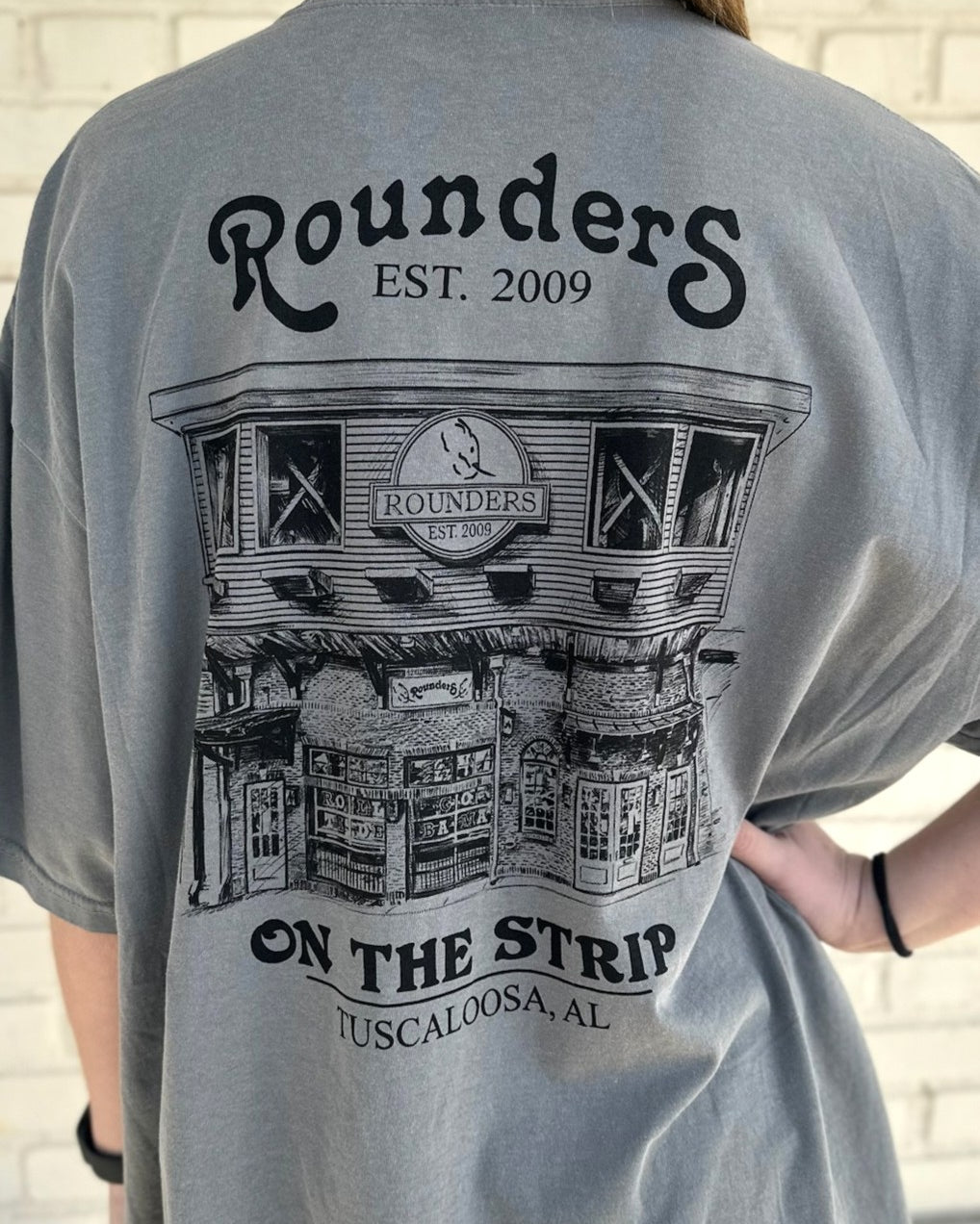 Rounders Grey Tee with a Black illustration of the Rounders Building