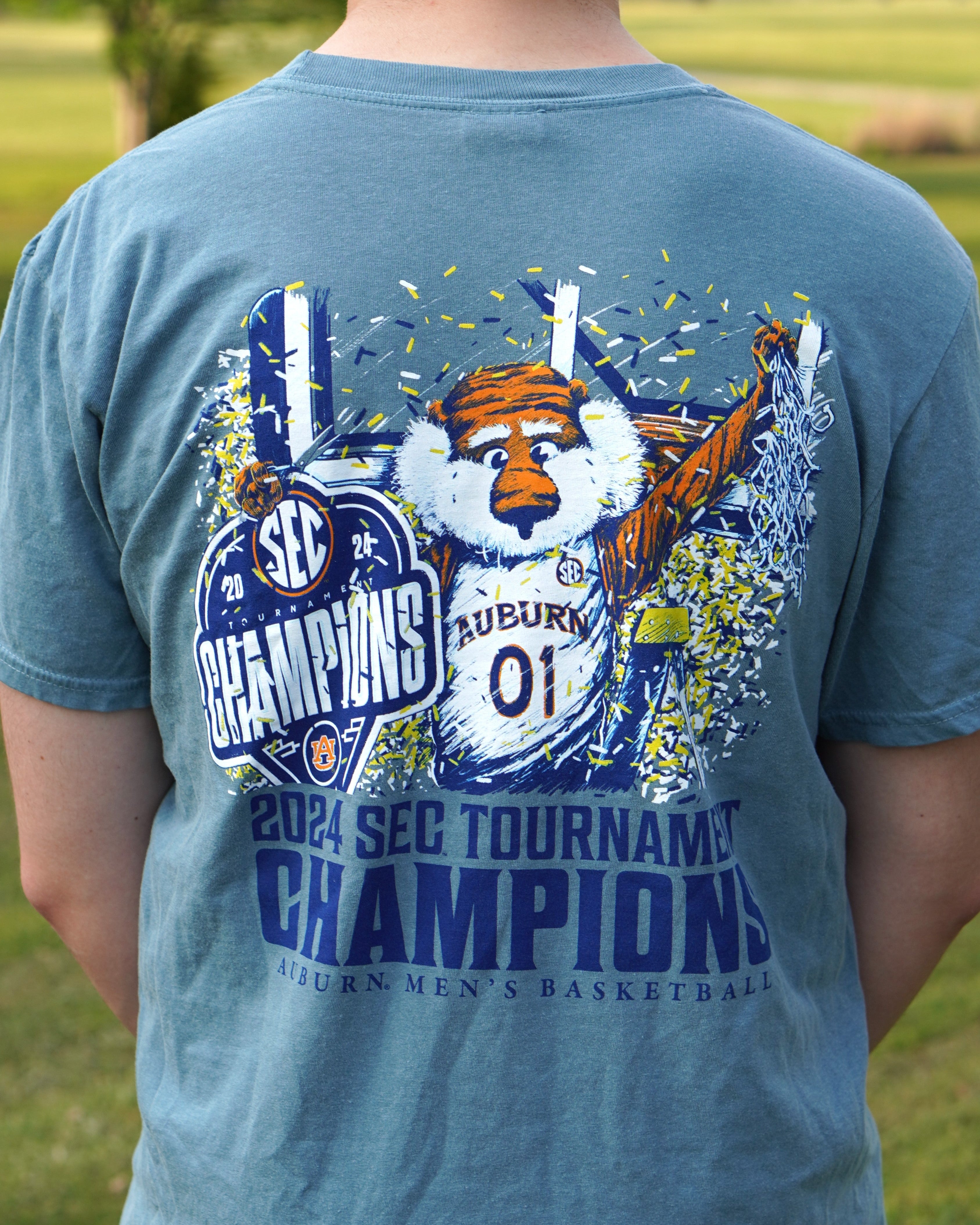 Auburn University Ice Blue SEC Champions T-Shirt with an illustration of Aubie holding an "SEC Champions" sign while confetti pours down around him